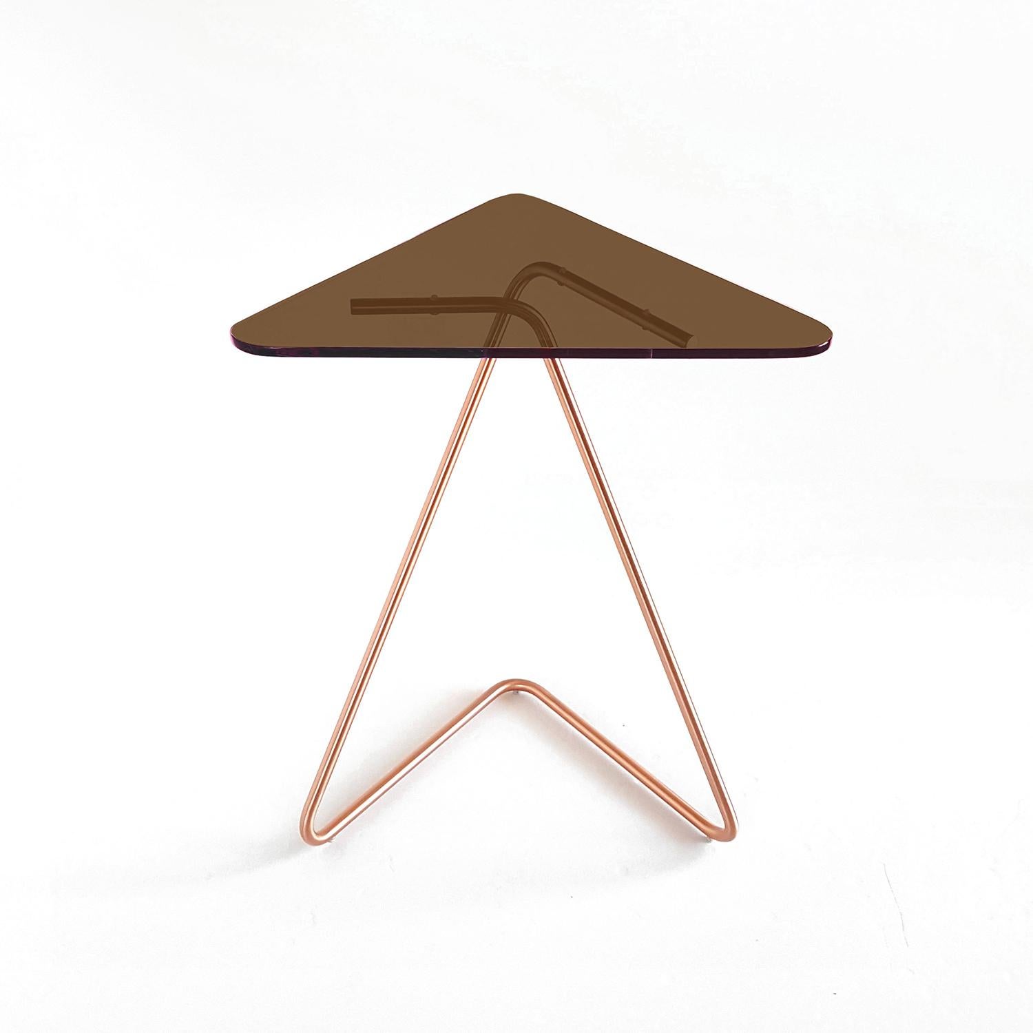 The Triangle side table by Rita Kettaneh 
Dimensions: The base: brushed stainless steel plated with copper
 optionally plated with copper or brass
 The top: acrylic
Materials: H 49.5 x W 41 x D 9.5 cm
Weight: 2.6 Kg

Colors and Finishes: