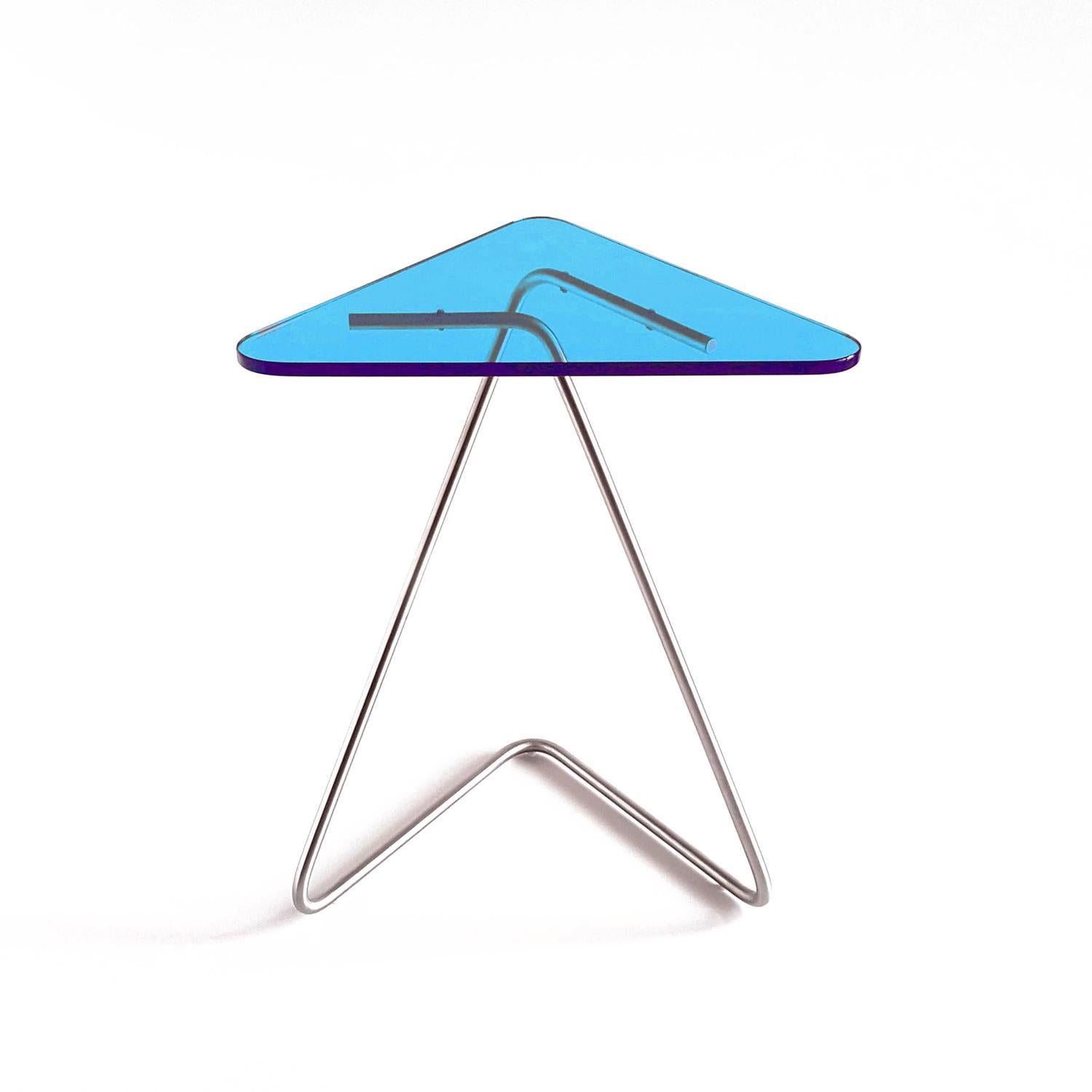 The triangle side table by Rita Kettaneh 
Dimensions: The base: brushed stainless steel 
 Optionally plated with copper or brass
 The top: acrylic
Materials: H 49.5 x W 41 x D 9.5 cm
Weight: 2.6 Kg

Colors and finishes: 
Stainless finish:
