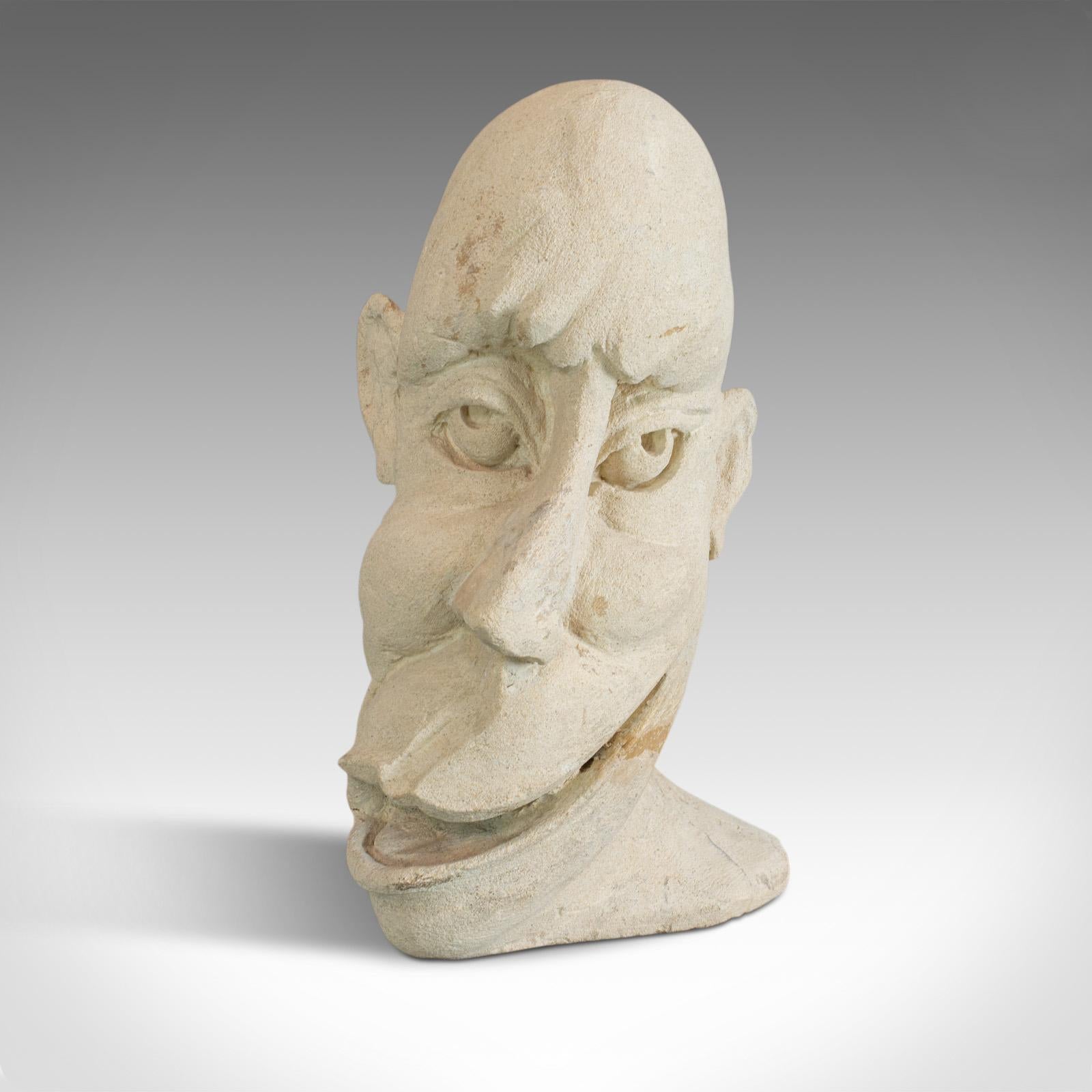 'The Twisted Face' is an individual bust by renowned sculptural artist Dominic Hurley. An English, bath stone sculpture dating to the 20th century.

Hand carved from a single form of famous bath stone
Jovial facial detail adds to the
