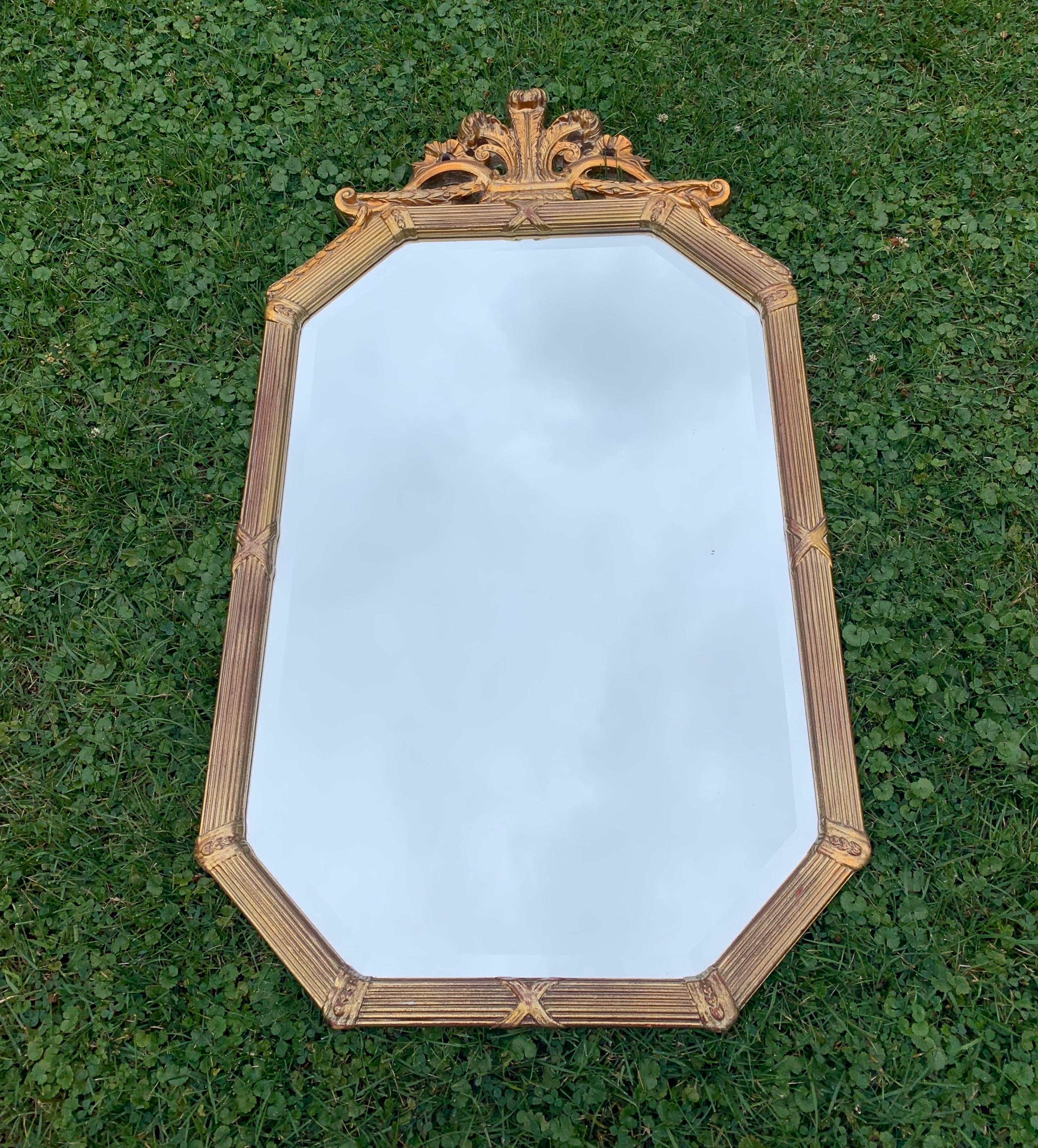 Trumeau wall mirror with gilded carved wood frame by the Uttermost Company. Virginia, USA, circa 1980.

All wood frame. Signed with inked stamp to back. Includes attached hooks.
