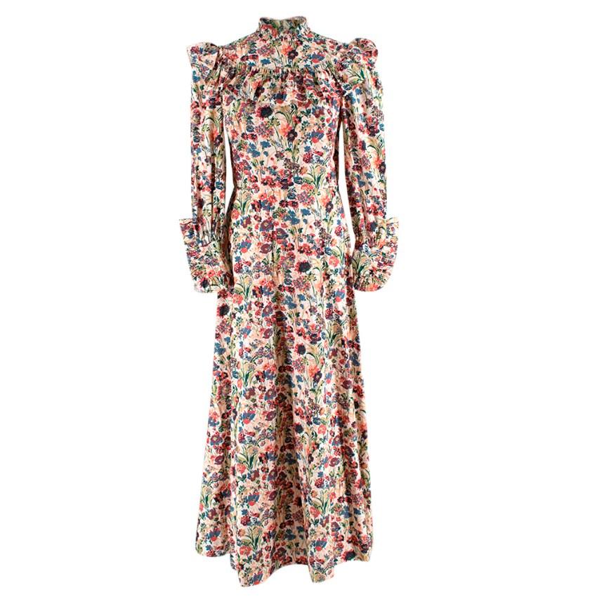 Cut from floral printed cotton poplin, The Firefly Dress features long sleeves, a lightly tailored bodice and a high ruffled neckline. A curved ruffle yoke frames the shoulders, and frills accent the neck and detailed buttoned sleeve cuffs. A-line