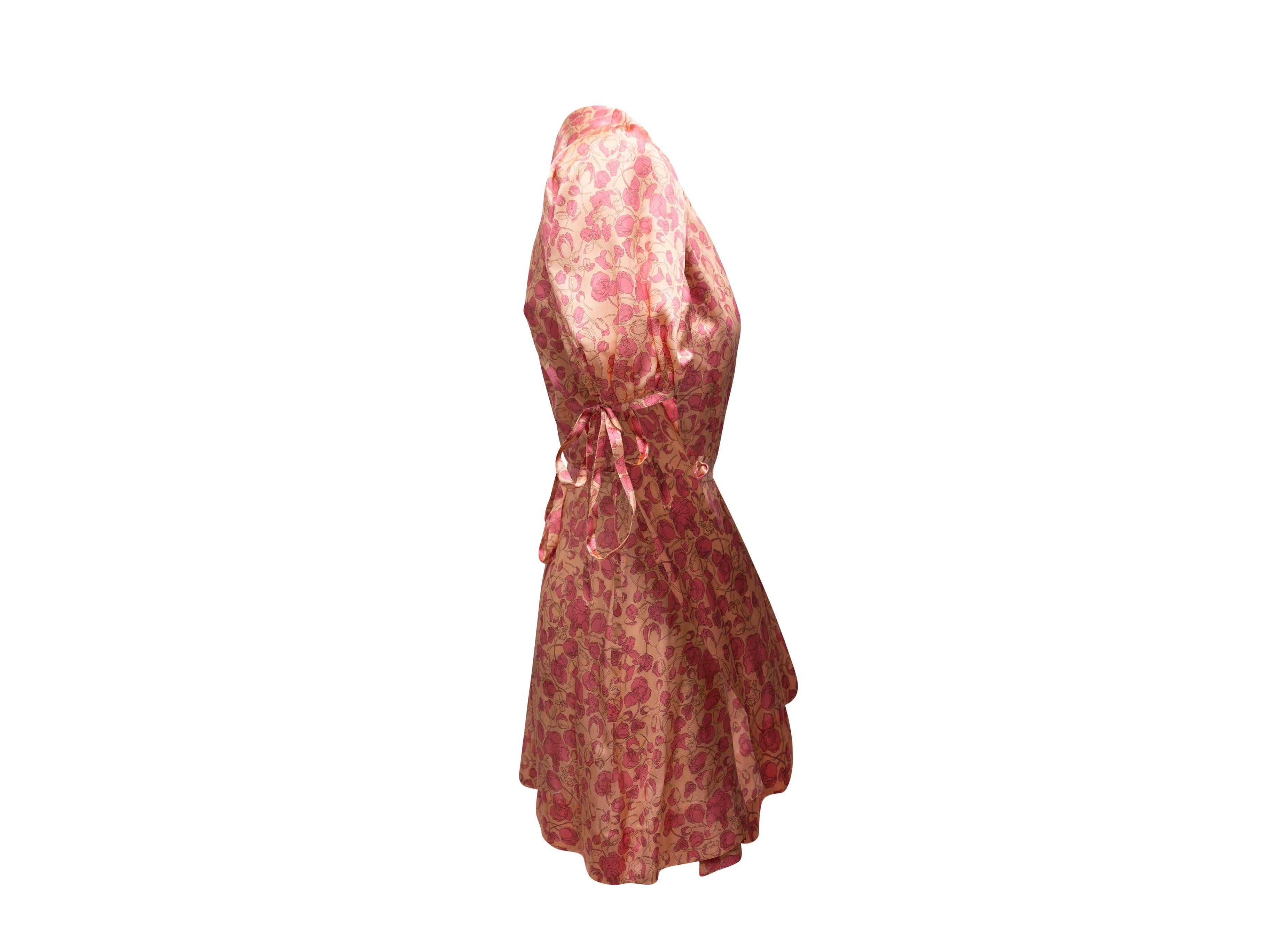 Product details: Peach and pink silk floral print wrap dress by The Vampire's Wife. Short puff sleeves. Tie closure at waist. 30