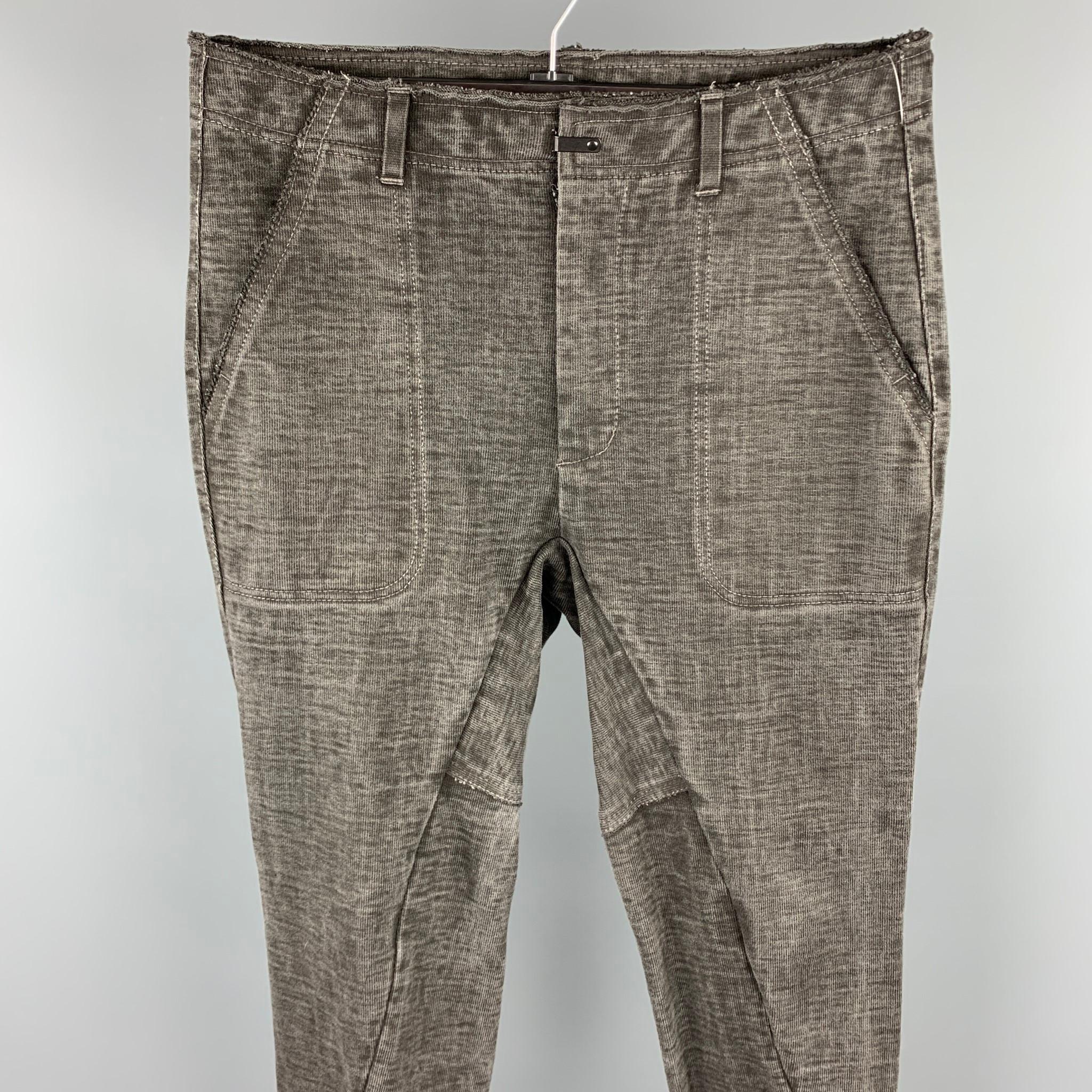 THE VIRIDI-ANNE casual pants comes in a charcoal washed cotton featuring an asymmetrical design, raw edges, contrast stitching, front tab, and a zip fly closure. Made in Japan.

Very Good Pre-Owned Condition.
Marked: JP 4

Measurements:

Waist: 34