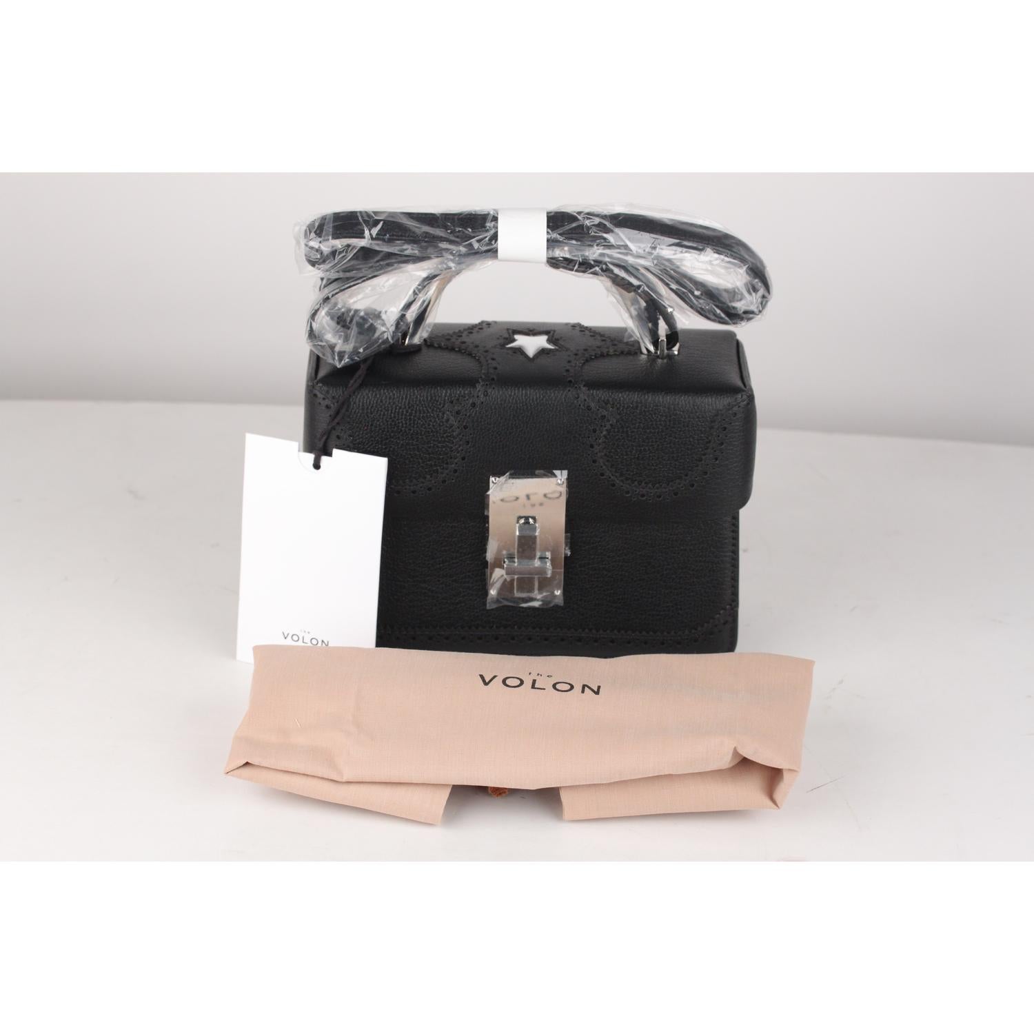 Beautiful black leather THE VOLON 'Data Alice' small crossbody bag. It features a structured design, accordion details on the side and brogue accents. This lovely bag has a round top handle and an adjustable and removable shoulder strap, silver