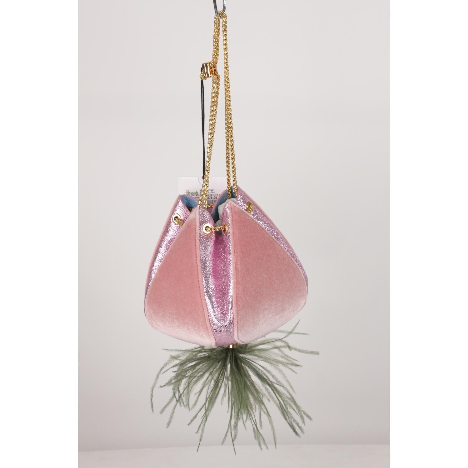 Beautiful THE VOLON 'Cindy' evening bag in pink velvet with metallic Pink textured leather. Inspired by Cinderella's pumpkin carriage, the bag features gray ostrich feather detail on the bottom. Gold metal double adjustable shoulder chain strap.
