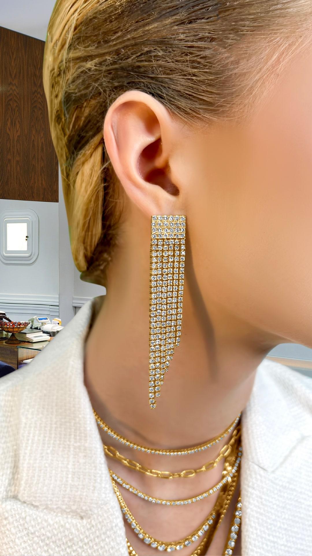 These luxurious earrings are crafted from 14k yellow gold and adorned with 384 natural diamonds, creating a stunning, flowing effect. Perfect for special occasions or elevating your everyday style, they are designed to make a bold