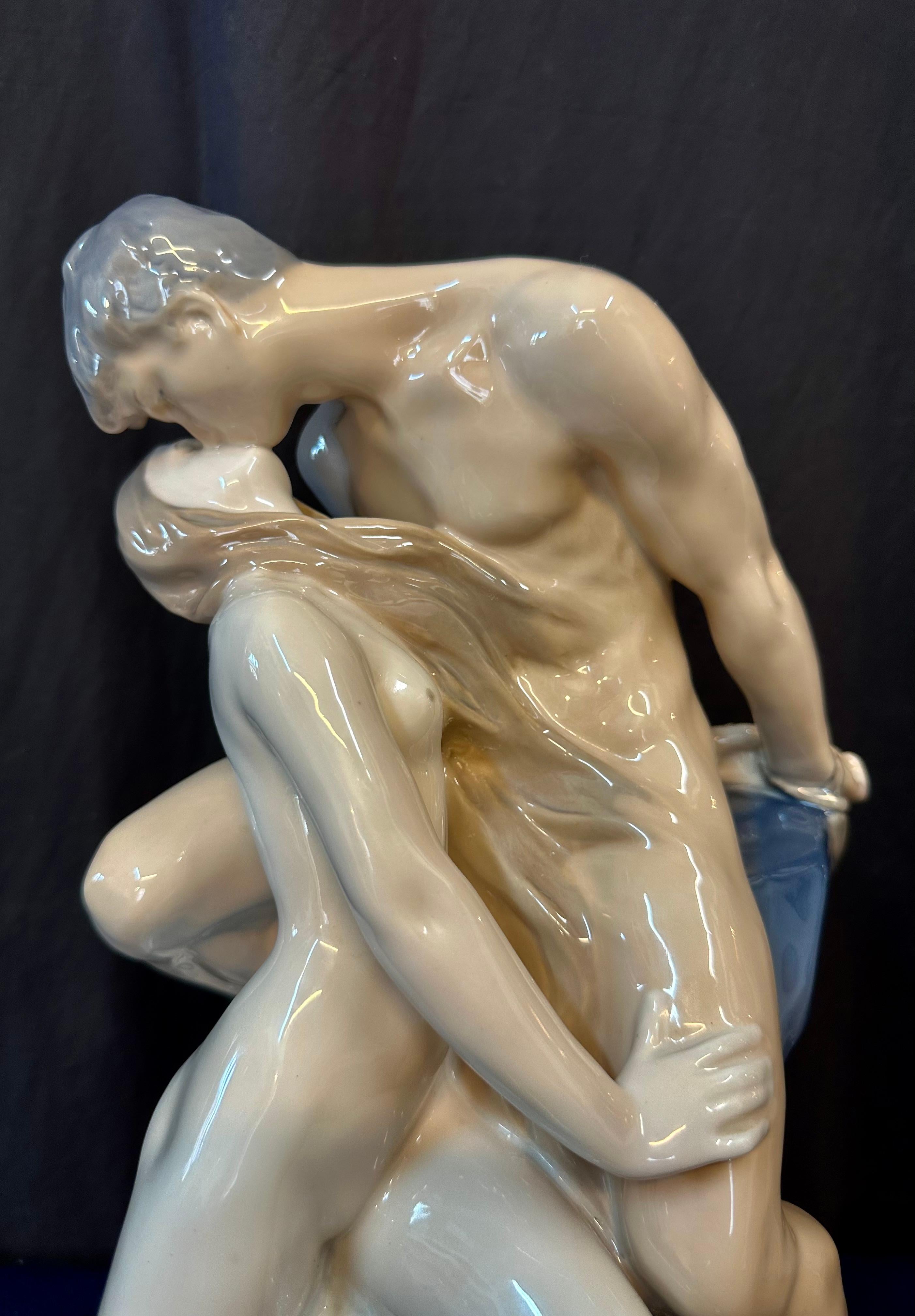 This vintage mid 20th century Continental porcelain statue was designed by the Royal Copenhagen Company of Denmark. It has a few titles, the most well known being “The Wave & the Rock”. It depicts a seductive water nymph ravishin g her male captive