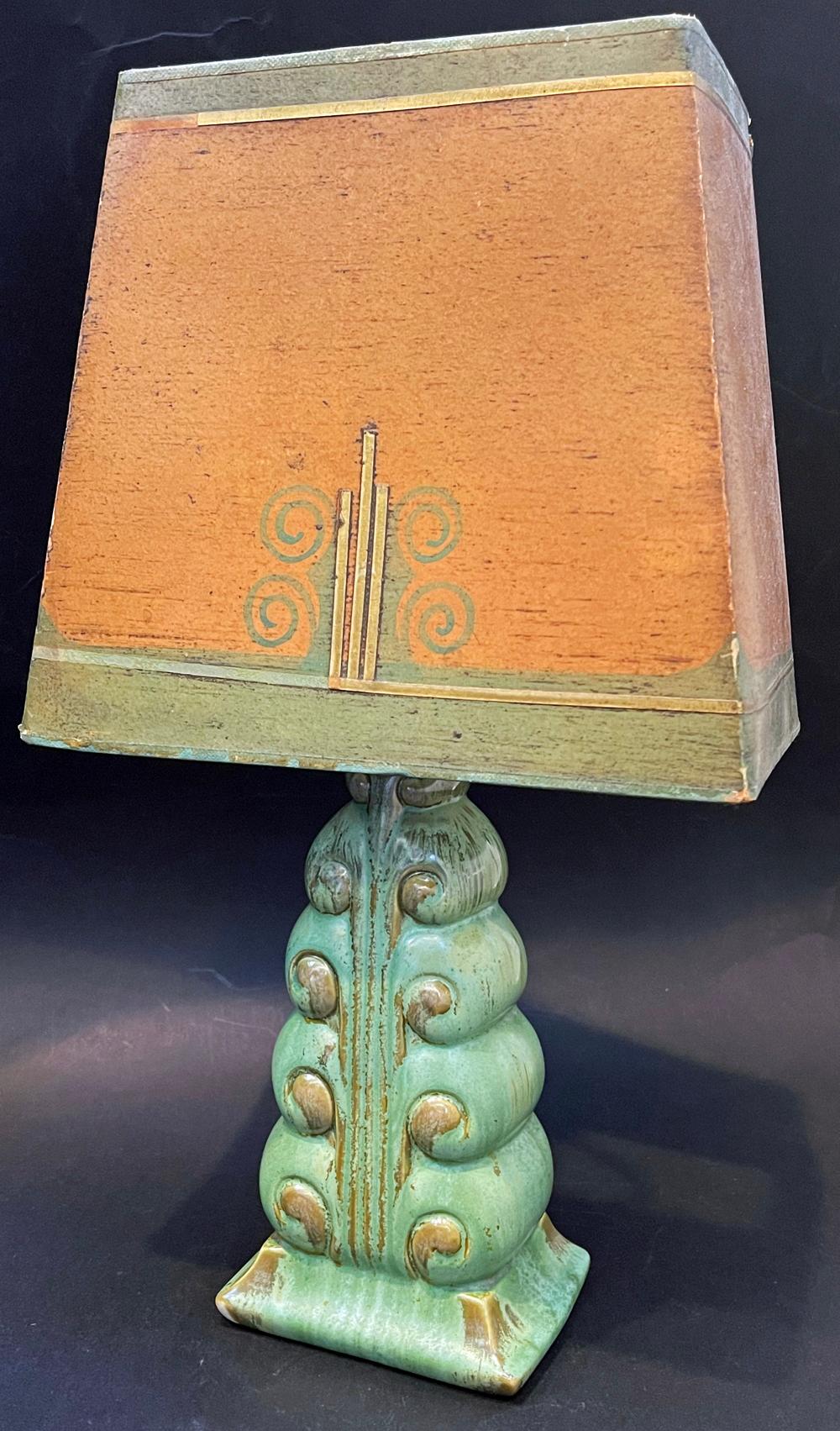 Extraordinary in its rarity and fine design, this green and gold glazed table lamp by sculptor Waylande Gregory was made by the famed Cowan pottery works near Cleveland and includes its original, hand crafted parchment shade in soft pumpkin and