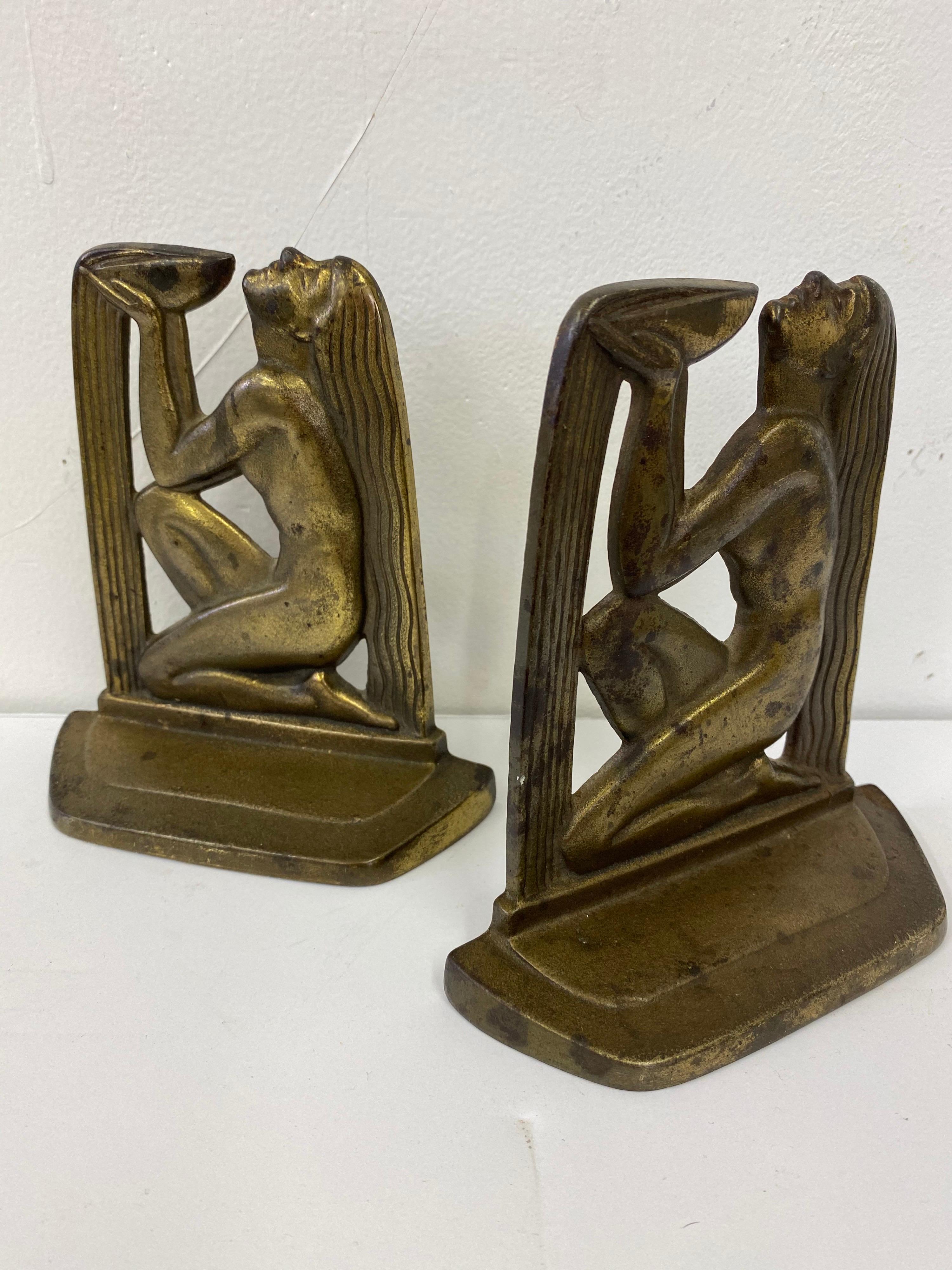 The well of wisdom iron bookends. Dated 1929 with a brass or bronze patina. All original and in good shape! Everyone needs a little wisdom!