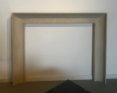 The Westchester: A Modern Carved Stone Fireplace with a Concave Profile