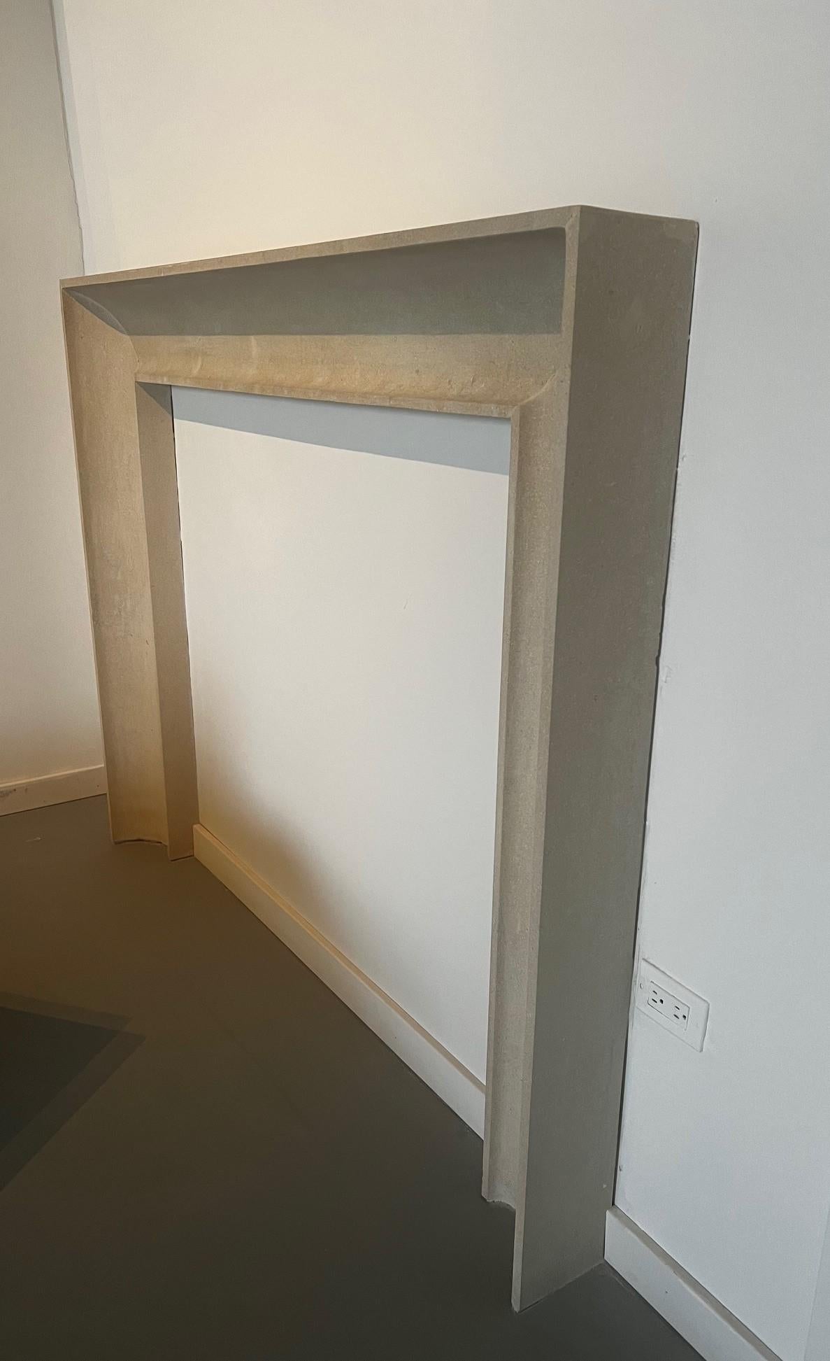 American The Westchester: A Modern Carved Stone Fireplace with a Concave Profile For Sale