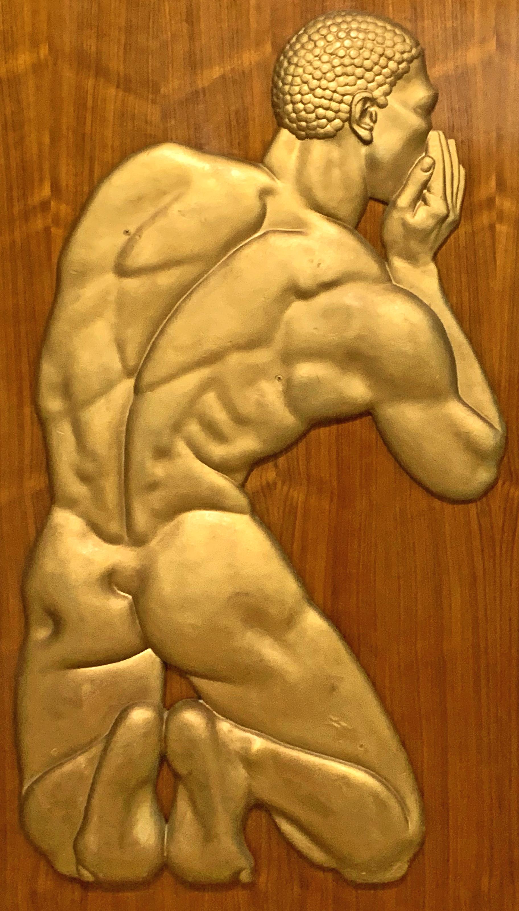 Extremely fine and unique, this large gold-finished plaster bas relief sculpture of a kneeling Black male figure, whispering into the ear of an unseen companion, once graced the lobby of an Art Deco hotel in Florida. The sculptor captured the form