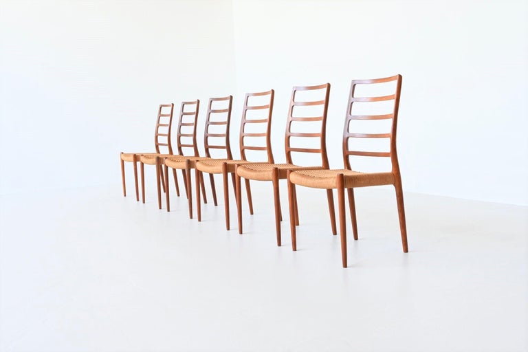 Amazing set of six dining chairs model 82 designed by Niels Otto Møller and manufactured by J.L. Møller Mobelfabrik, Denmark 1971. These beautiful elegant shaped chairs are made of solid teak wood and the seats are upholstered with paper cord. The