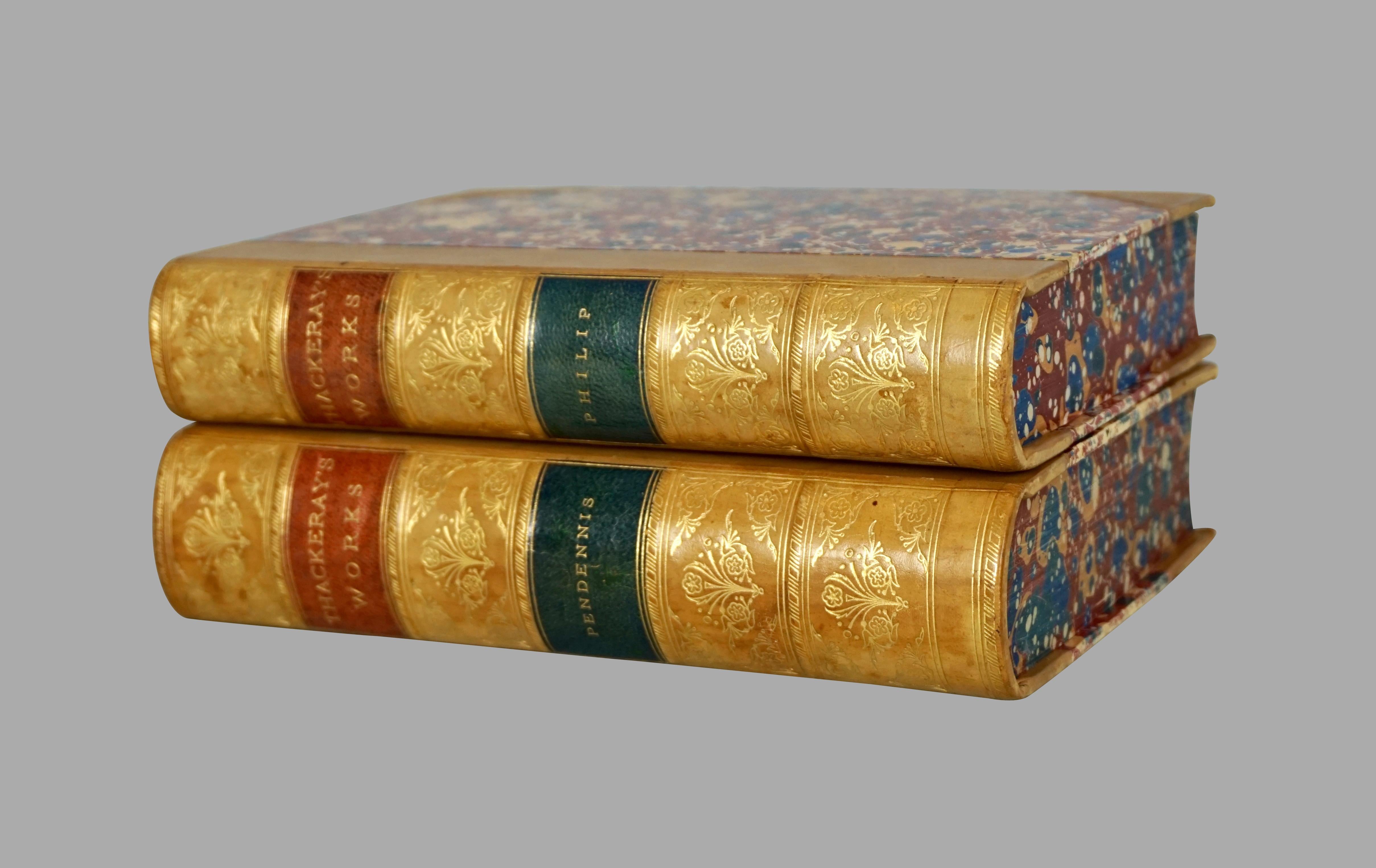 A complete set of 12 leather bound and marbleized paper works of William Thackeray, the tan gilt tooled raised leather spines with red and black labels, published by Smith Elder & Company, London and J.R. Lippincott & Co. Philadelphia, 1879. An