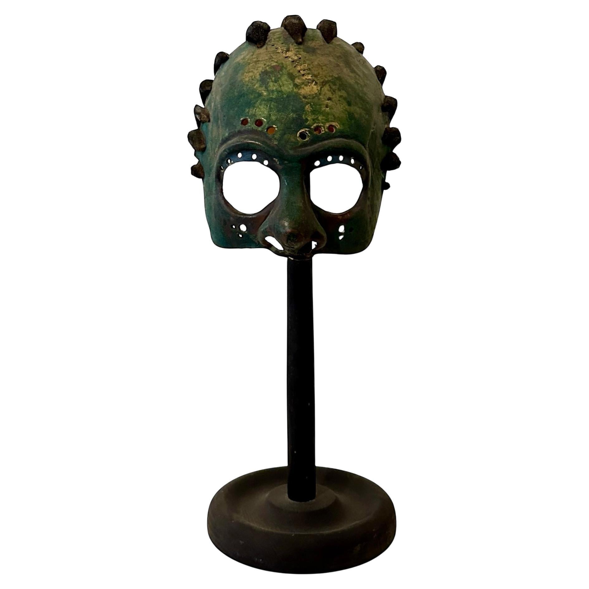 This striking theater mask by German artist Wolfgang Utzt was crafted in 1992 for a production of the play Ragtime. Expertly formed from treated leather, the mask embodies Utzt’s distinctive approach to theatrical design—combining traditional