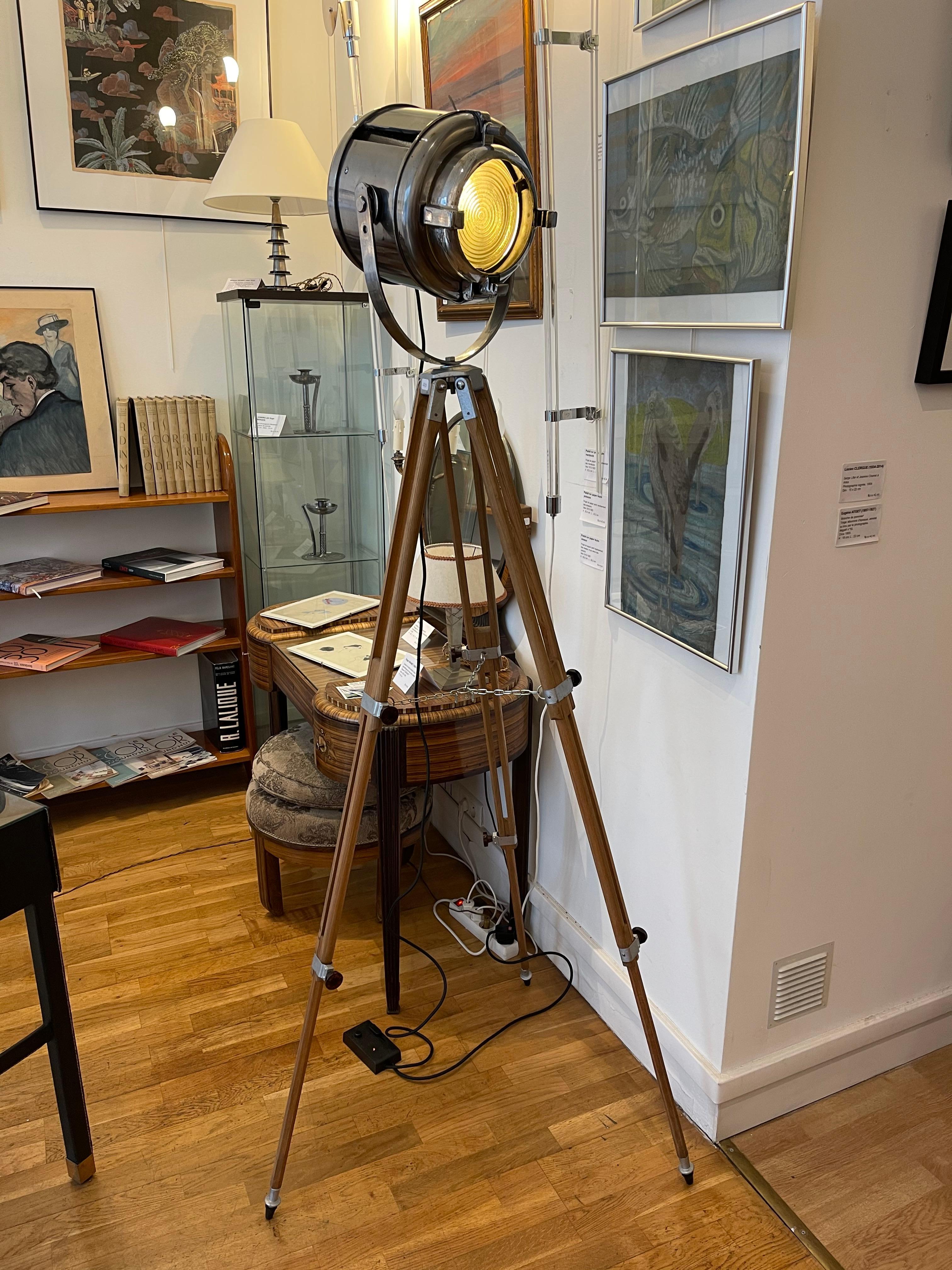 Vintage theater spotlight by Furse (from a London theater), steel body, Fresnel lens, dimmer switch, rewired, mounted on a vintage retractable wooden tripod. The spotlight has been polished to show the metal. The light has been converted for home