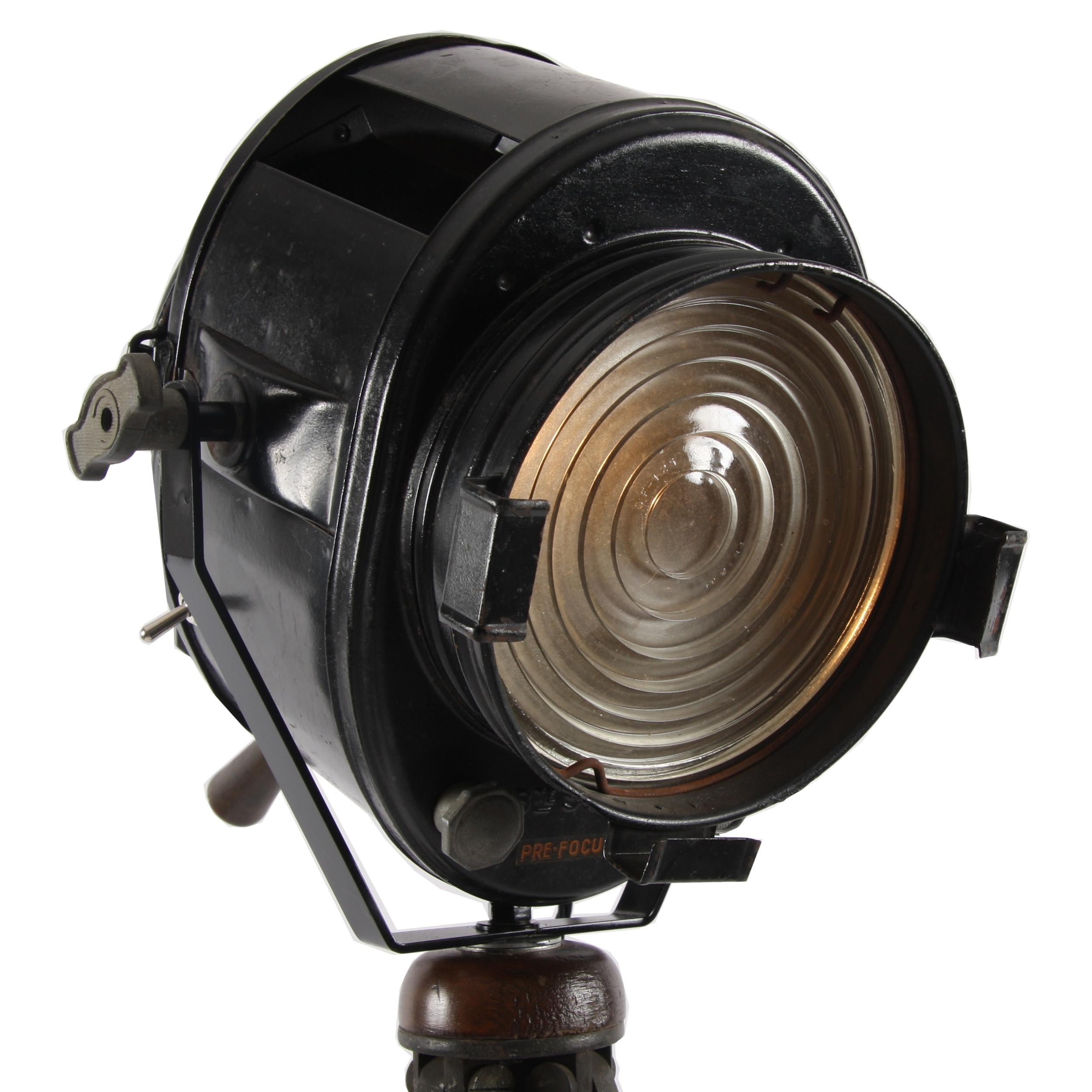 This gorgeous theatre light was made by A. E Cramer in Paris in the 1920s. It sits on a superb solid mahogany tripod Stand and the maker's mark is stamped on the back of the light itself.

A stunning piece!
 
