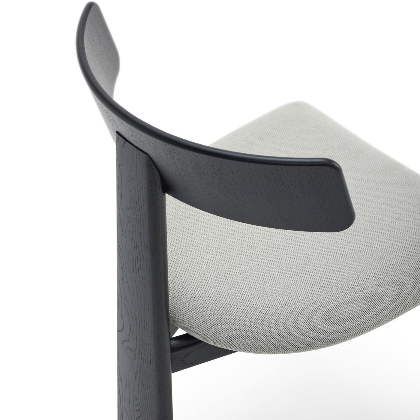 Theo is an ash wood chair designed by Balutto Associati. The seat can be upholstered in fabric or leather, ideal for enriching any room with a touch of elegance and comfort. Please, contact the Concierge for further information.