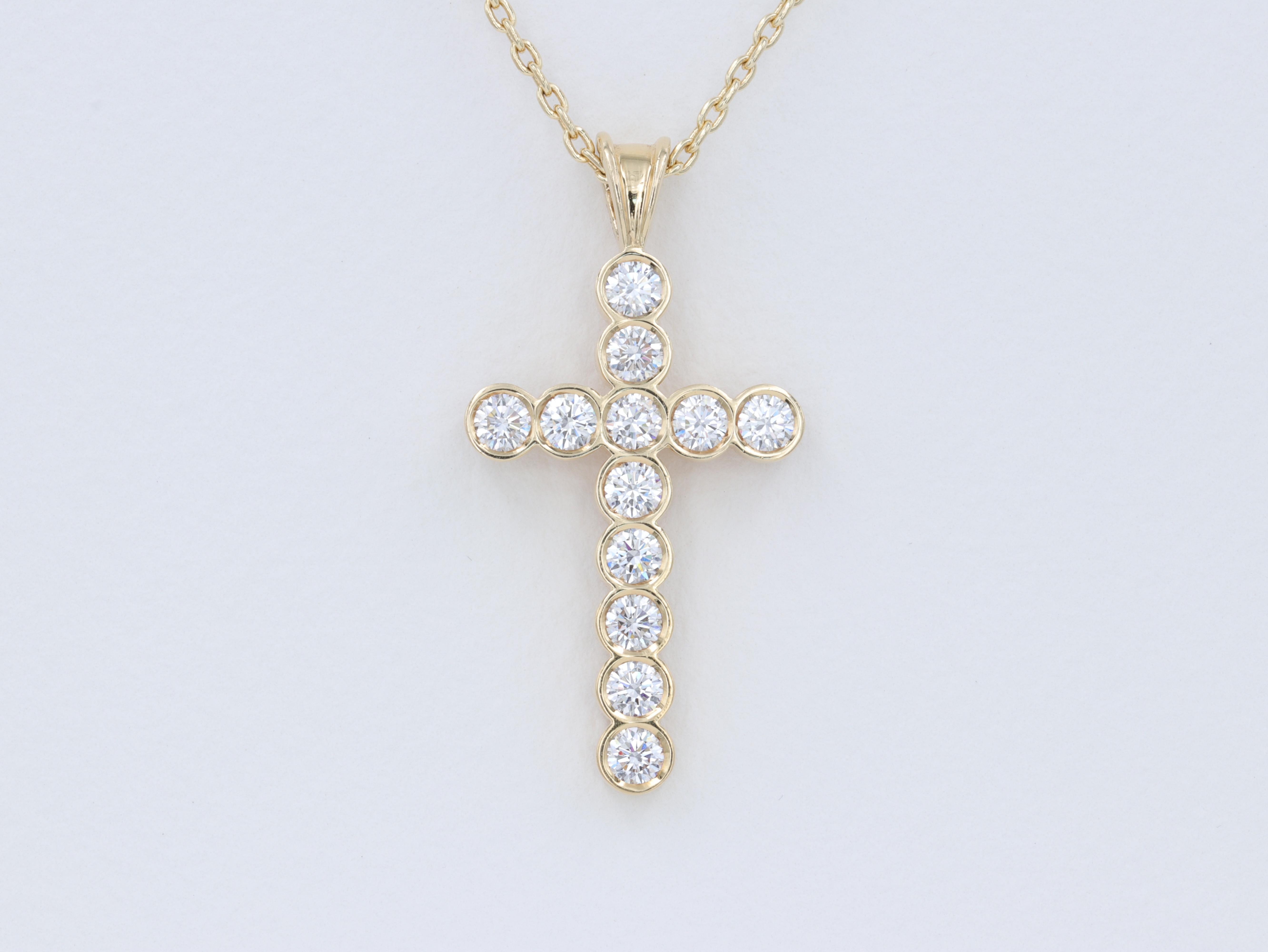 The cross perfected by Theo Fennell, with extreme attention to detail in all elements of this hand crafted cross, with ideal cut round brilliant cut diamonds sharply set in a bezel set design of perfect proportions.

The diamonds weigh 2.01 carats