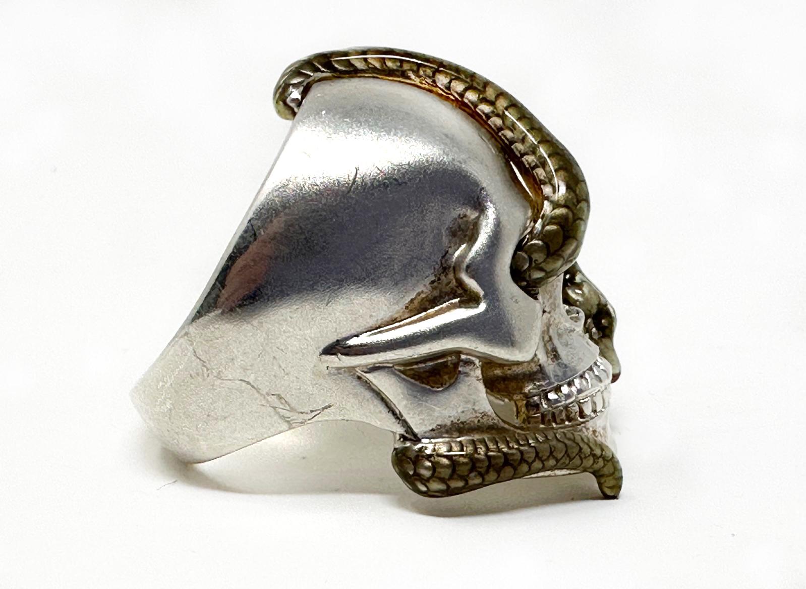 Theo Fennell Alias Sterling Silver and Enamel Snake Skull Ring. Heavy ring 39.8grams. Big, and bold!
Detailed Gray/black enamel snake. The face of the ring measures approximately 35.4mm at its widest and the band measures 6.1mm wide at the rear.