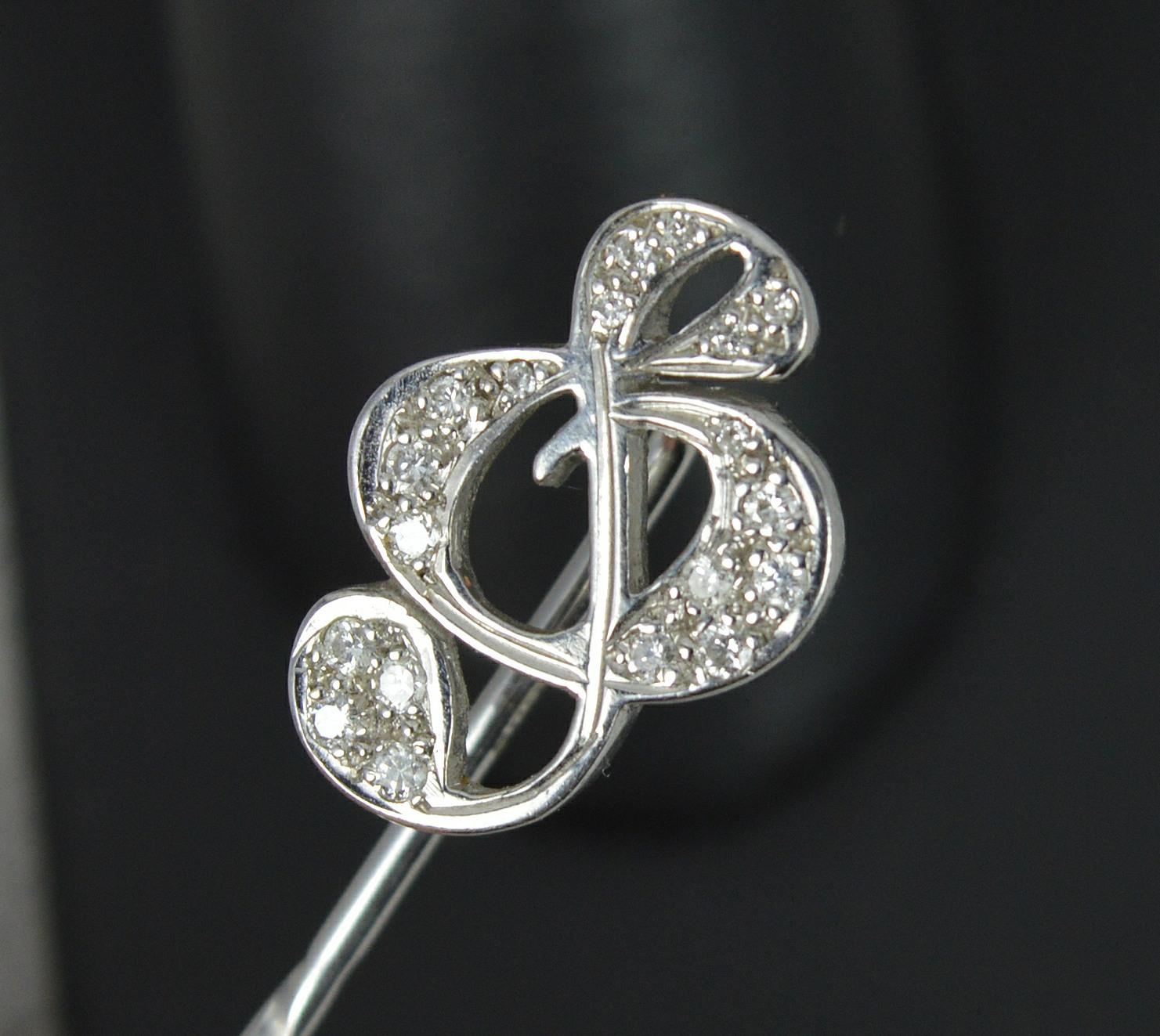 A beautiful Theo Fennell Designer stick or tie pin.
Solid 18 carat white gold example.
Designed with a musical treble clef note to the top.
Set with 18 natural round brilliant cut diamonds.

CONDITION ; Very good. Clean, solid example. Well set