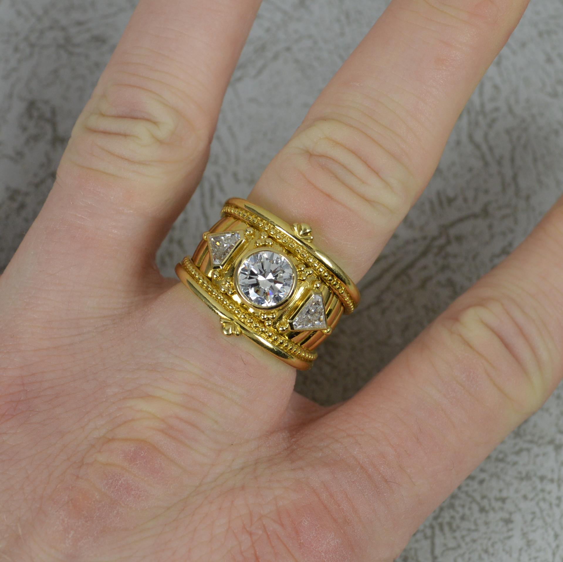 A superb 18ct gold and diamond ring by Theo Fennell.
18 carat yellow gold shank and bezel settings.
Designed with a round brilliant cut diamond to centre, 6.9mm diameter, 1.3 carats approx. Vs clarity, G-H colour. A well cut, very sparkly