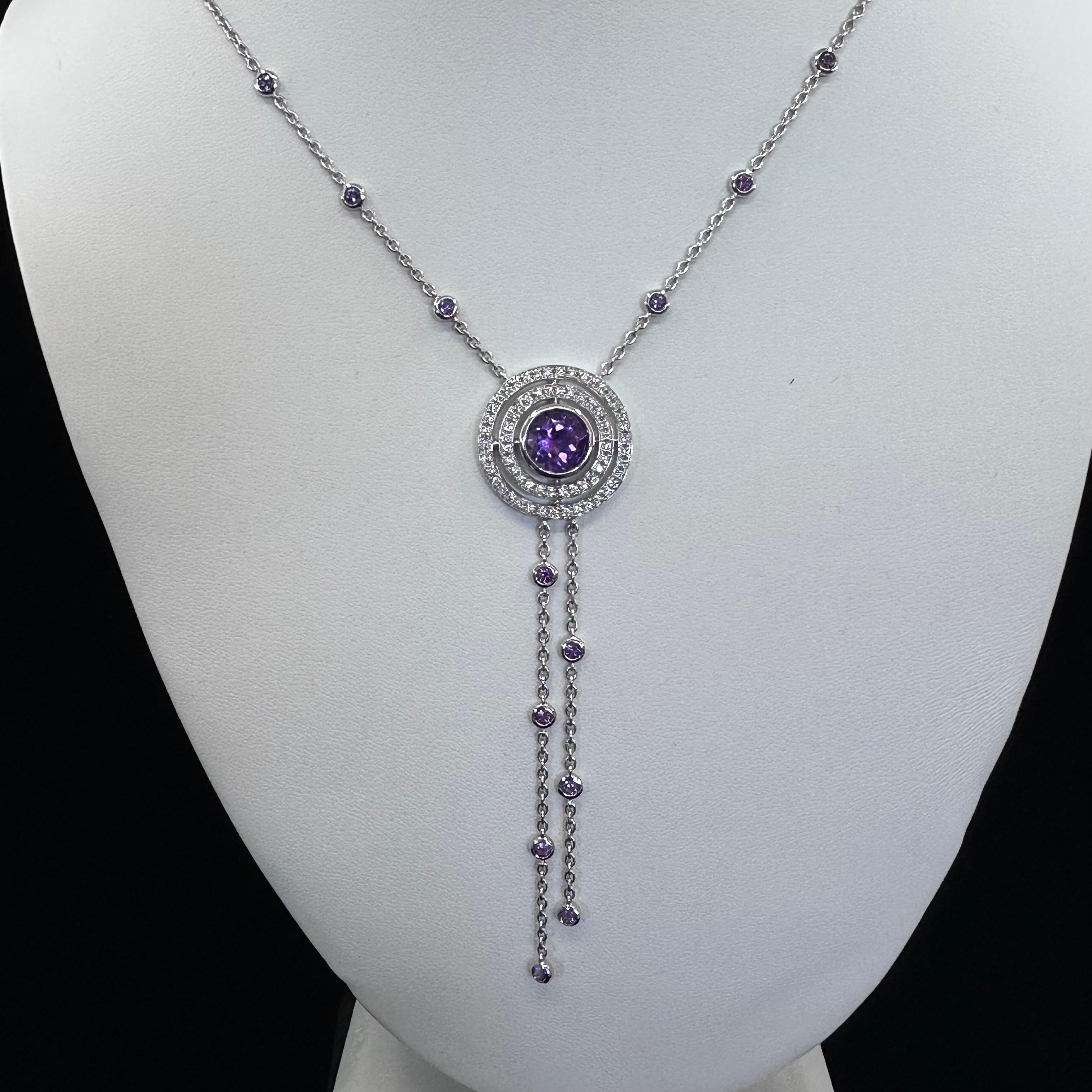 Theo Fennell
Amethyst Diamond Necklace
18k White Gold 12.57 g
One Round Amethyst 8mm x 5mm Est Weight: 3.50 cts
Numerous round diamonds in two circular halo Pave Setttings
Chain Length 17 Inches with a 3 Inch Drop
The amethyst pendant in the center