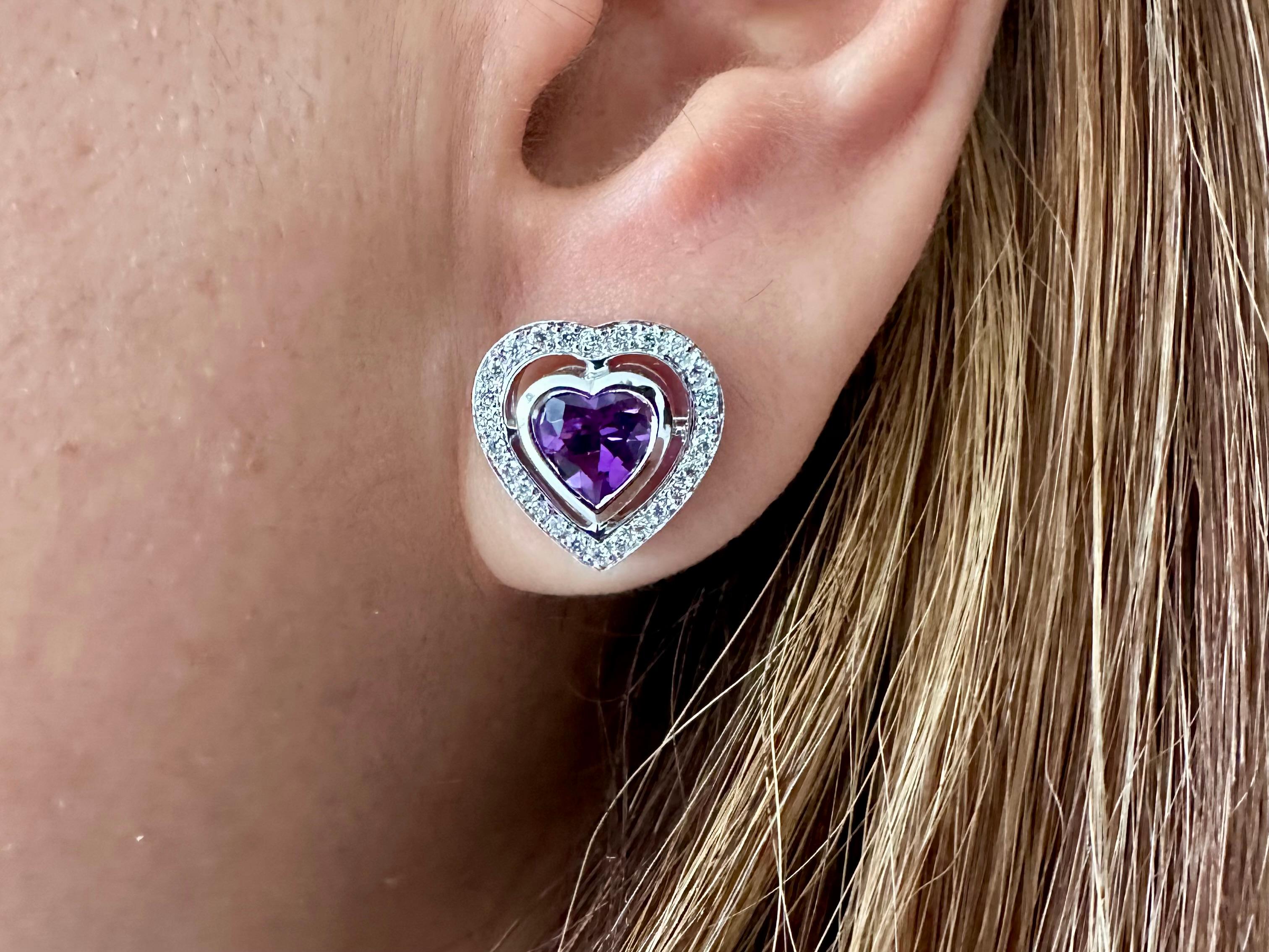 Theo Fennell Earrings
Two heart-shaped Russian Amethyst Est 1.25cts Each
2.50 cts total Amethyst and 52 Round Diamonds .50 cts Total  Surrounded by Numerous Round Brilliant Cut Diamond Pave set in 18k White Gold
Stud Earrings with Friction