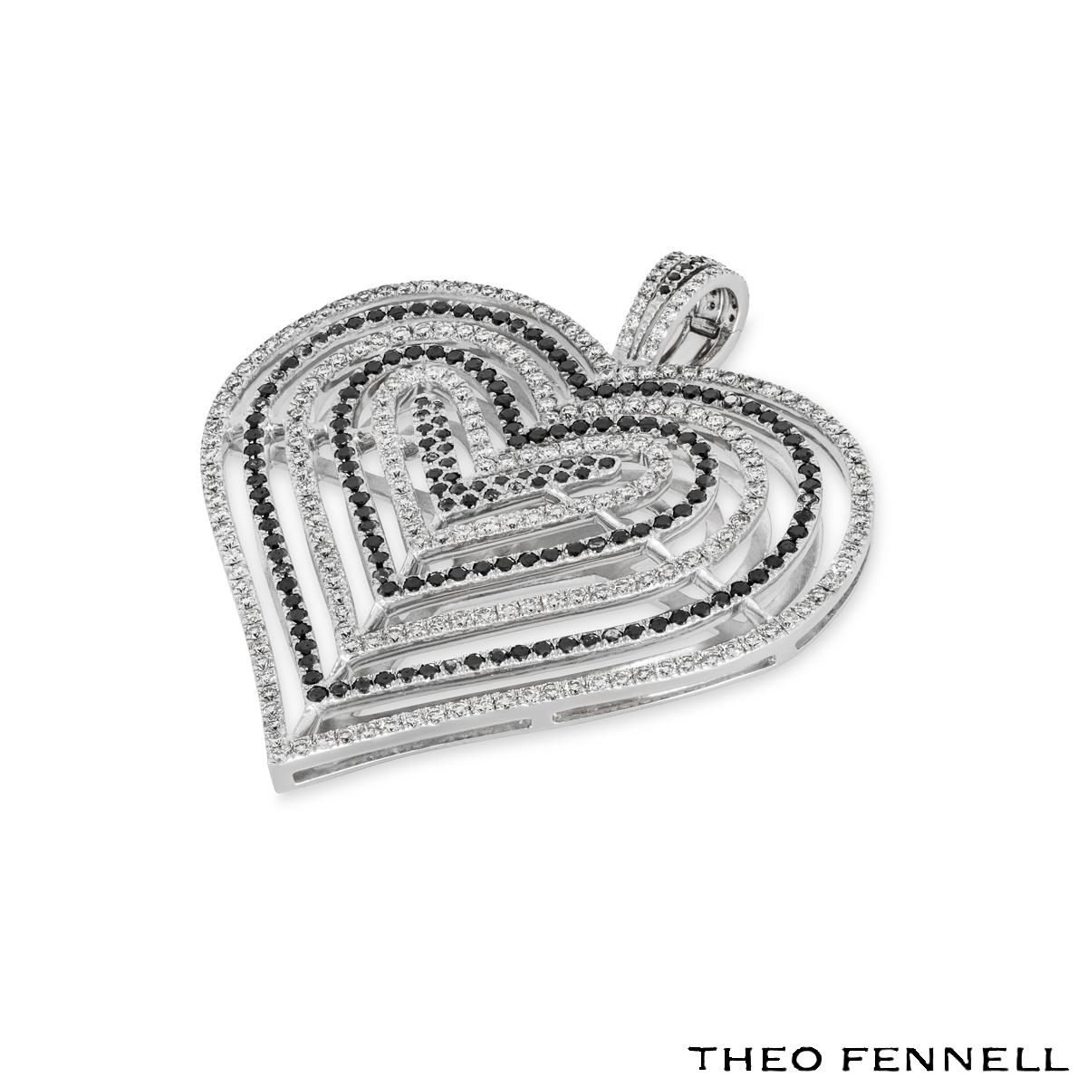A striking 18k white gold Theo Fennell diamond pendant. The pendant comprises of an open work design with 6 hearts. Each heart has round brilliant cut diamonds in a pave setting alternating with black diamonds and white diamonds. There are 160 black