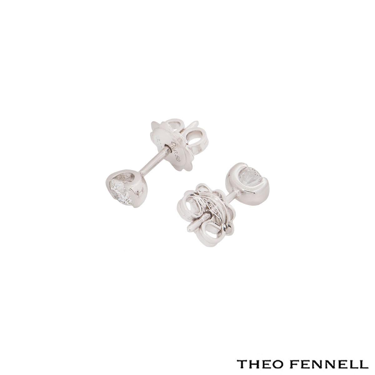 A beautiful pair of 18k white gold diamond stud earrings by Theo Fennell. The earrings comprise of a single round brilliant cut diamond in a half rubover setting with a total weight of 0.50ct, G colour and VS1. The earrings have a length of 1.30cm
