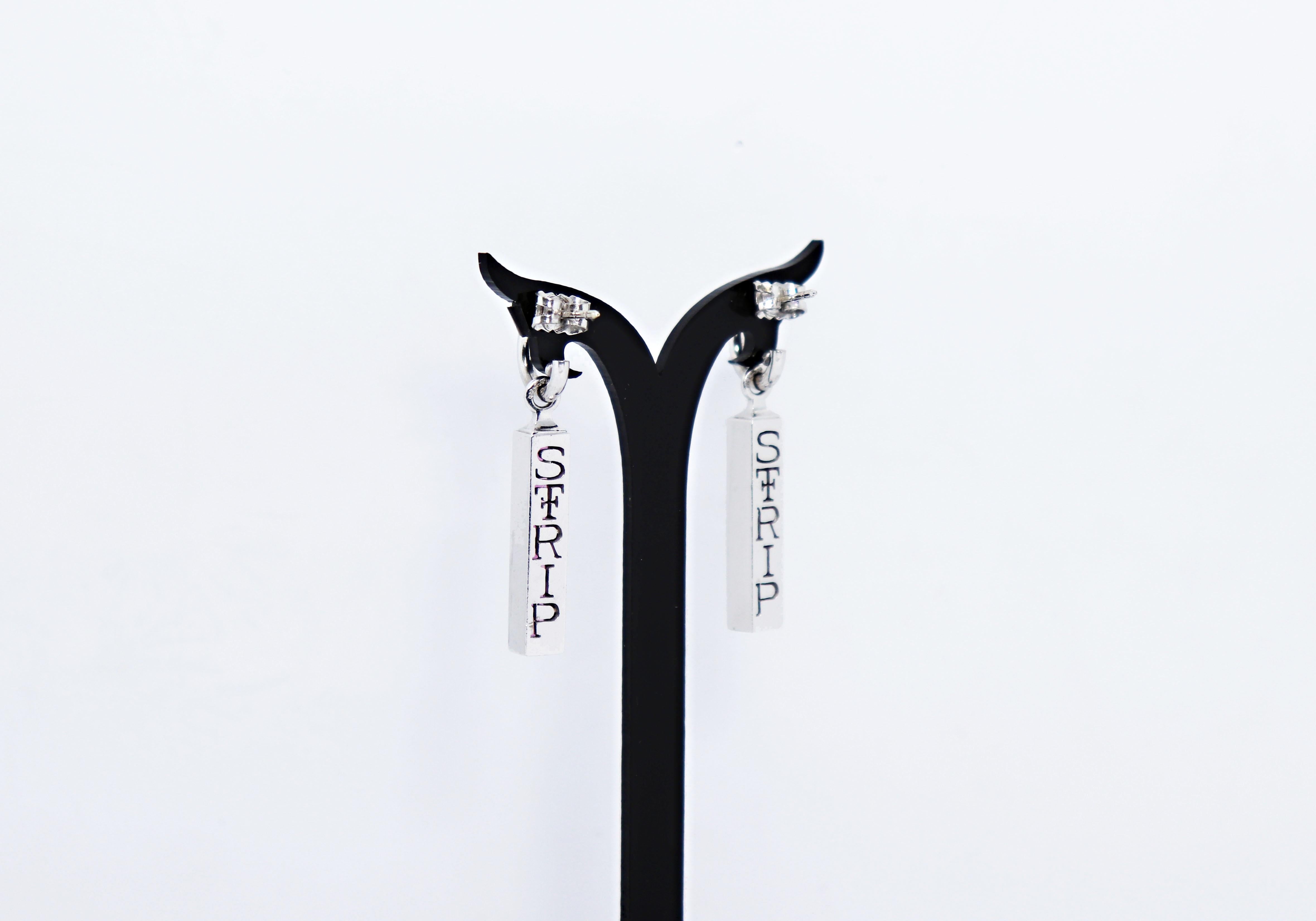 Contemporary Theo Fennell drop earrings from their STRIP collection. Each earring features an 18ct white gold 11mm (diameter) 3/4 hoop, from which suspends a removable bar, each channel set with six fine quality square shaped pink tourmalines. Each