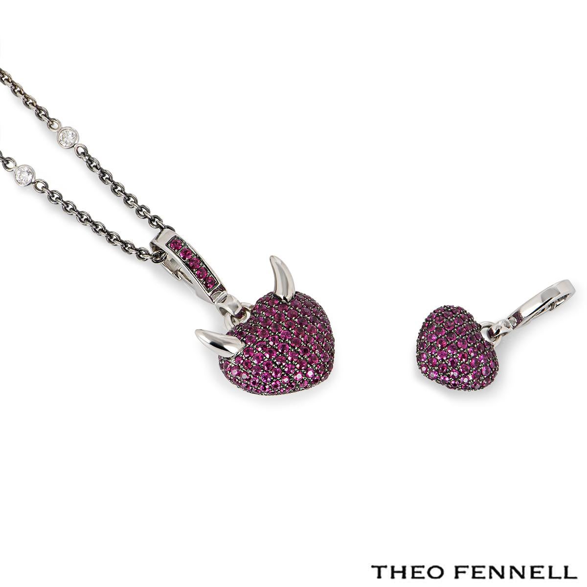 A captivating 18k white gold ruby & diamond jewellery suite by Theo Fennell from the 'Arts collection. The suite comprises of a pendant on chain and a charm. The pendant features a heart motif with devil horns and is pave set with round rubies to