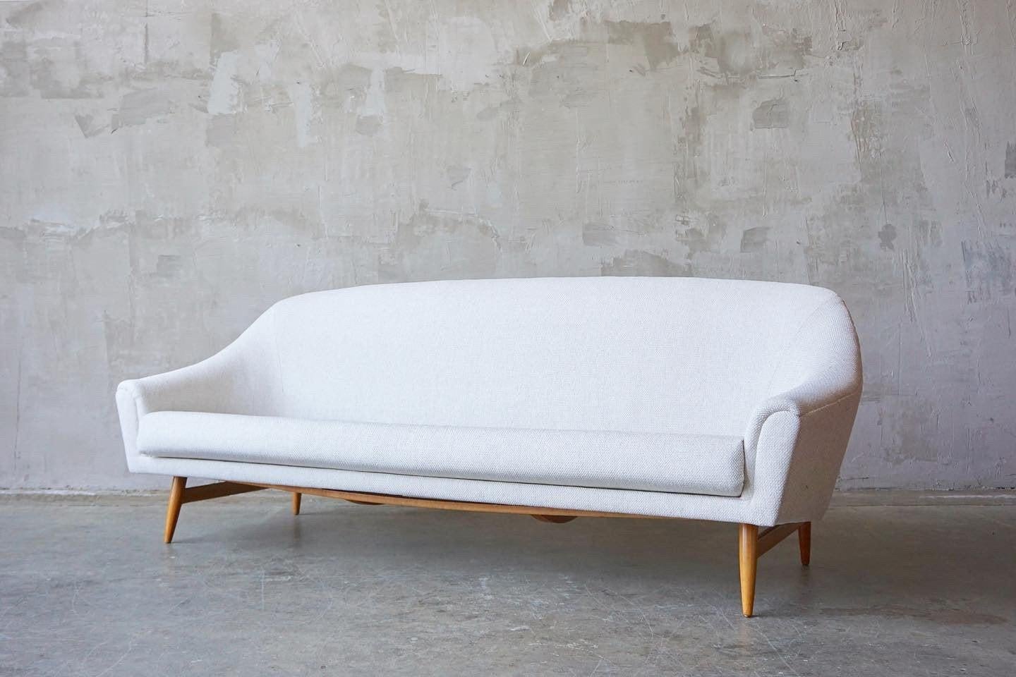 Offered by F&F vintage, this beautifully designed bracket-back sofa attributed to Theo Ruth, circa 1960s. 

This piece has been expertly recovered in an off-white vintage tweed fabric. The solid wood legs have been refinished. 

Measures 81” W x