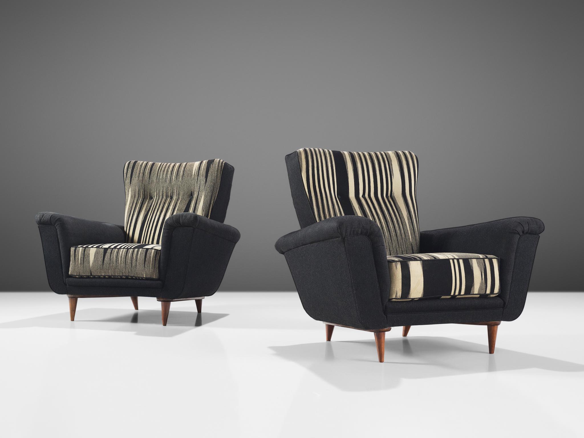 Theo Ruth for Artifort, pair of easy chairs, in original black and white fabric, wood, The Netherlands, 1950s.

This armchair is an iconic example of an Artifort piece furniture designed by Theo Ruth in the 1950s. The lounge chair is on the one