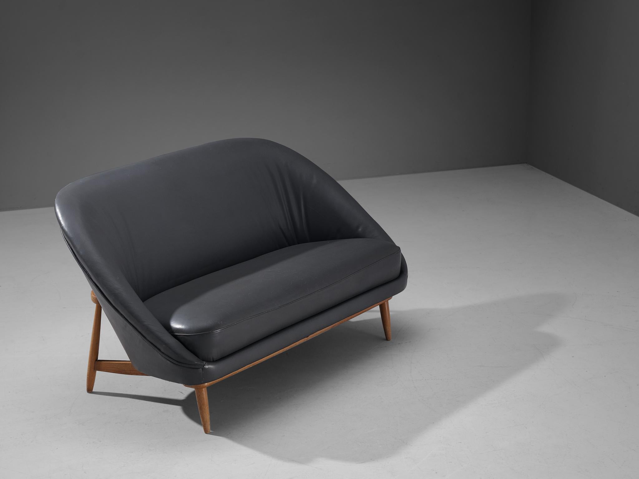 Theo Ruth for Artifort, sofa model '115', leather, stained beech, The Netherlands, 1950s

A Dutch settee by Theo Ruth currently upholstered in dark grey leather. The back tilts slightly backwards and has the recognizable natural flow and feel of