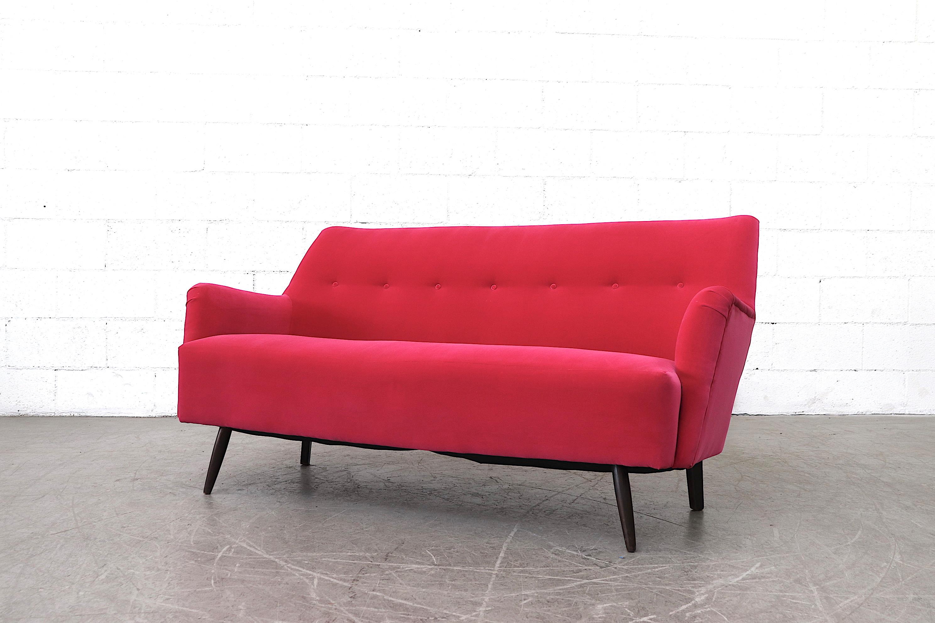 Theo Ruth loveseat by Artifort, newly upholstered fuchsia velvet with dark stained tapered legs. In original condition. Finn Juhl similarity. Matching lounge chairs available. Listed separately.