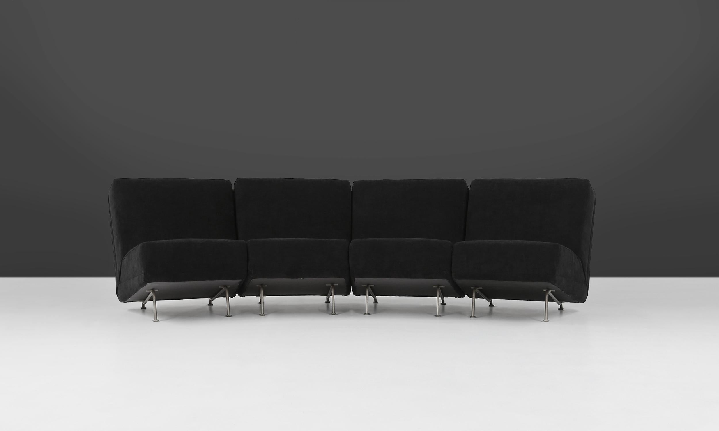 Modular seating group by Dutch designer Theo Ruth for Artifort in the 1950's. The four elements can be used separately or can be combined together as a four-seat sofa. These chairs have a metal base and a wooden structure with a fully reupholsterd