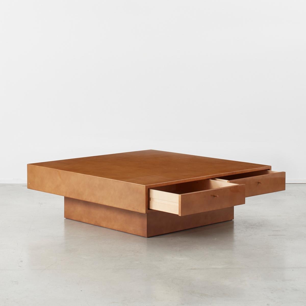 This is a one off piece designed by Theo Schulmann for his home, acquired from his personal collection. It sits on a recessed base giving it a light touch. The table is simple in form with a thick relaqué top concealing four draws, each with