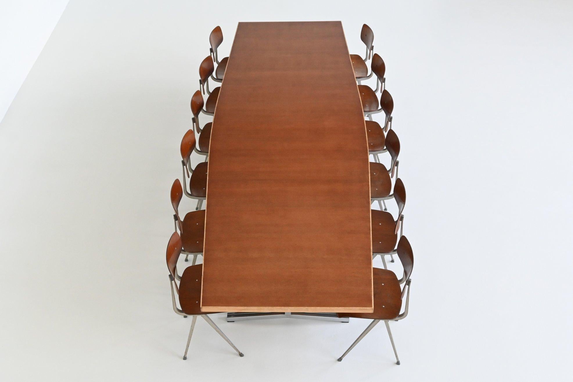 Magnificent large conference or dining table designed by Theo Tempelman for AP Originals, The Netherlands 1960. This exceptionally and unique table has a large, trapezium shaped tapered top made of nicely grained warm teak combined with a light oak