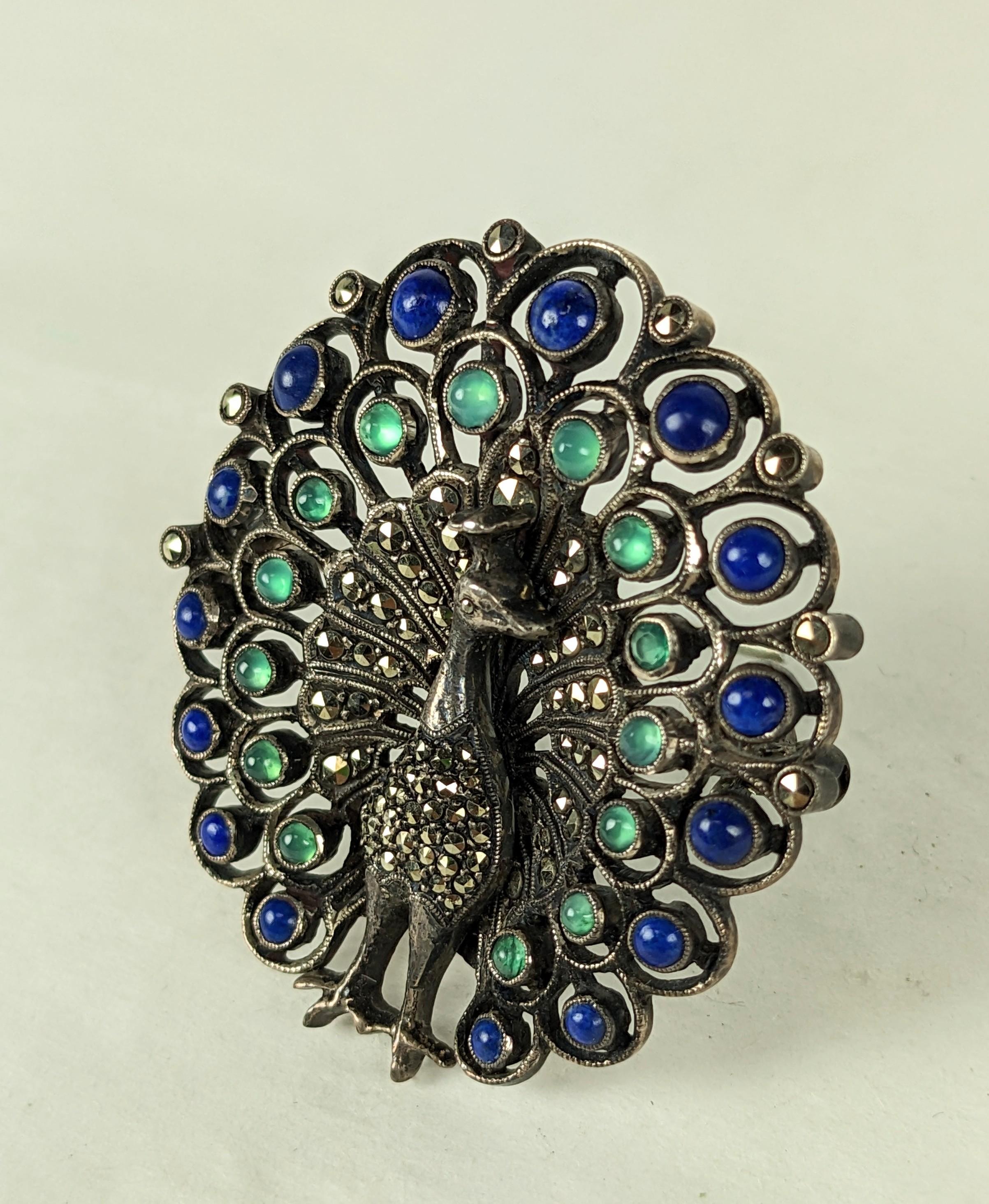 Rare Theodor Fahrner Gemstone Peacock Brooch from the Art Deco Period, 1930's Germany. Hand set with tiny marcasites with lapis lazuli and green onyx cabochons in a beautiful pierced setting. Signed with TF hallmark, 935 Sterling. 1930's Germany.