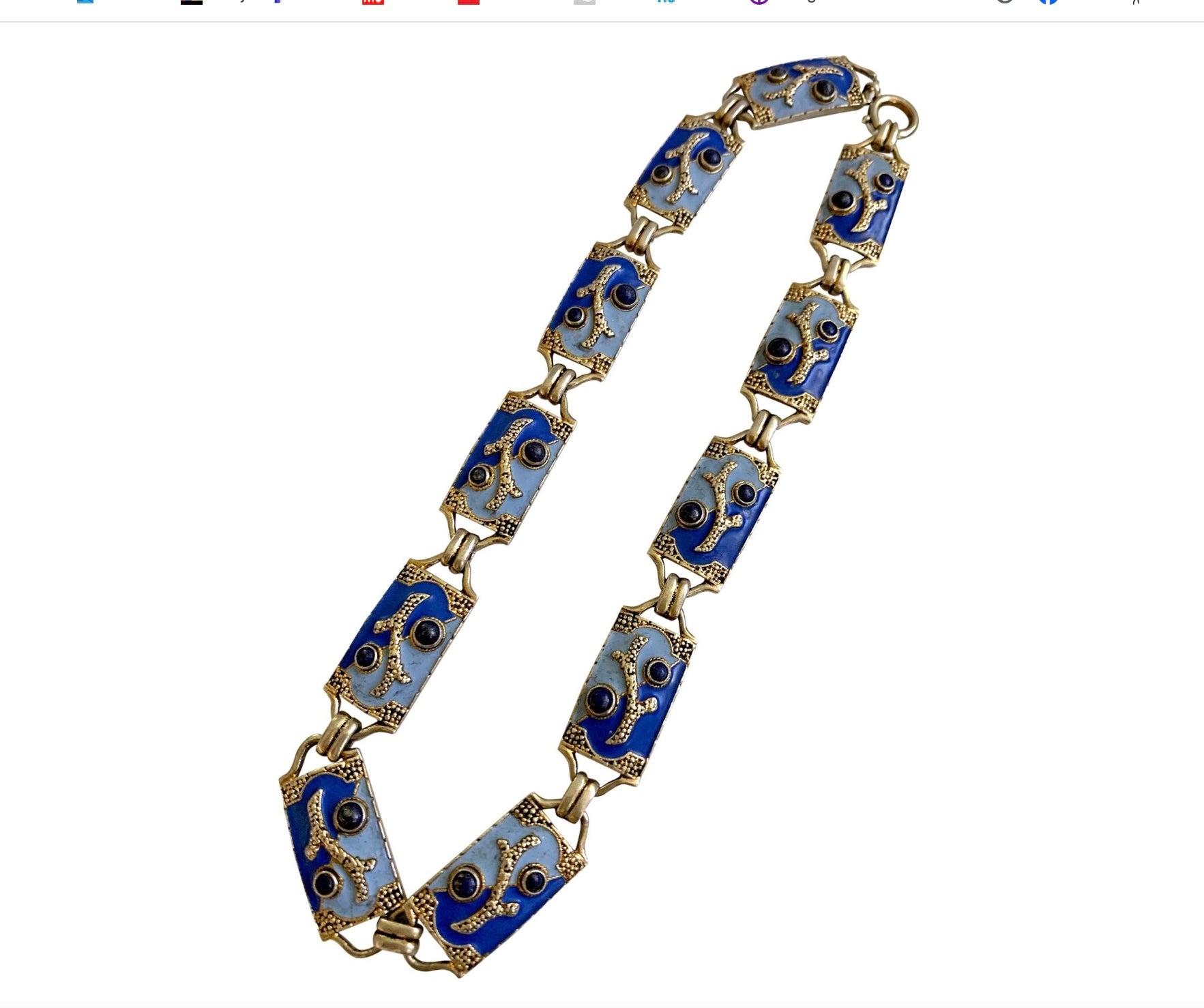 Indulge in a rare and wonderful Theodor Fahrner Necklace with Blue Enamel and Lapis Lazuli in a coral sea motif design in Sterling Silver.   This magnificent necklace is made up of 11 links featuring light and darker blue enamel with a gold scroll