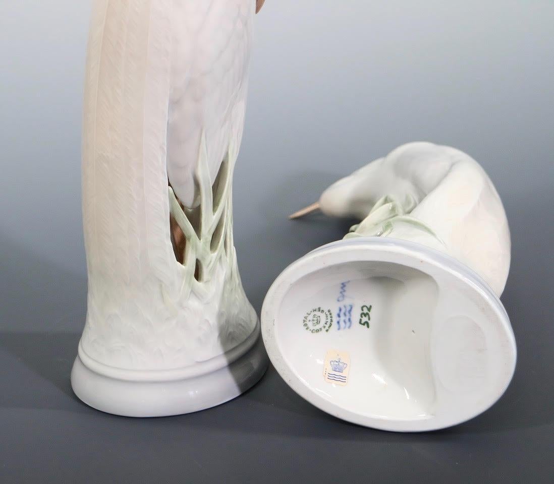 Swedish Art Deco pair of cranes or herons manufactured in porcelain by Royal Copenhagen and designed and molded by Theodor Madsen in the early 20th century. The pair has its original label and makers marks on the bottom and was made in Sweden during
