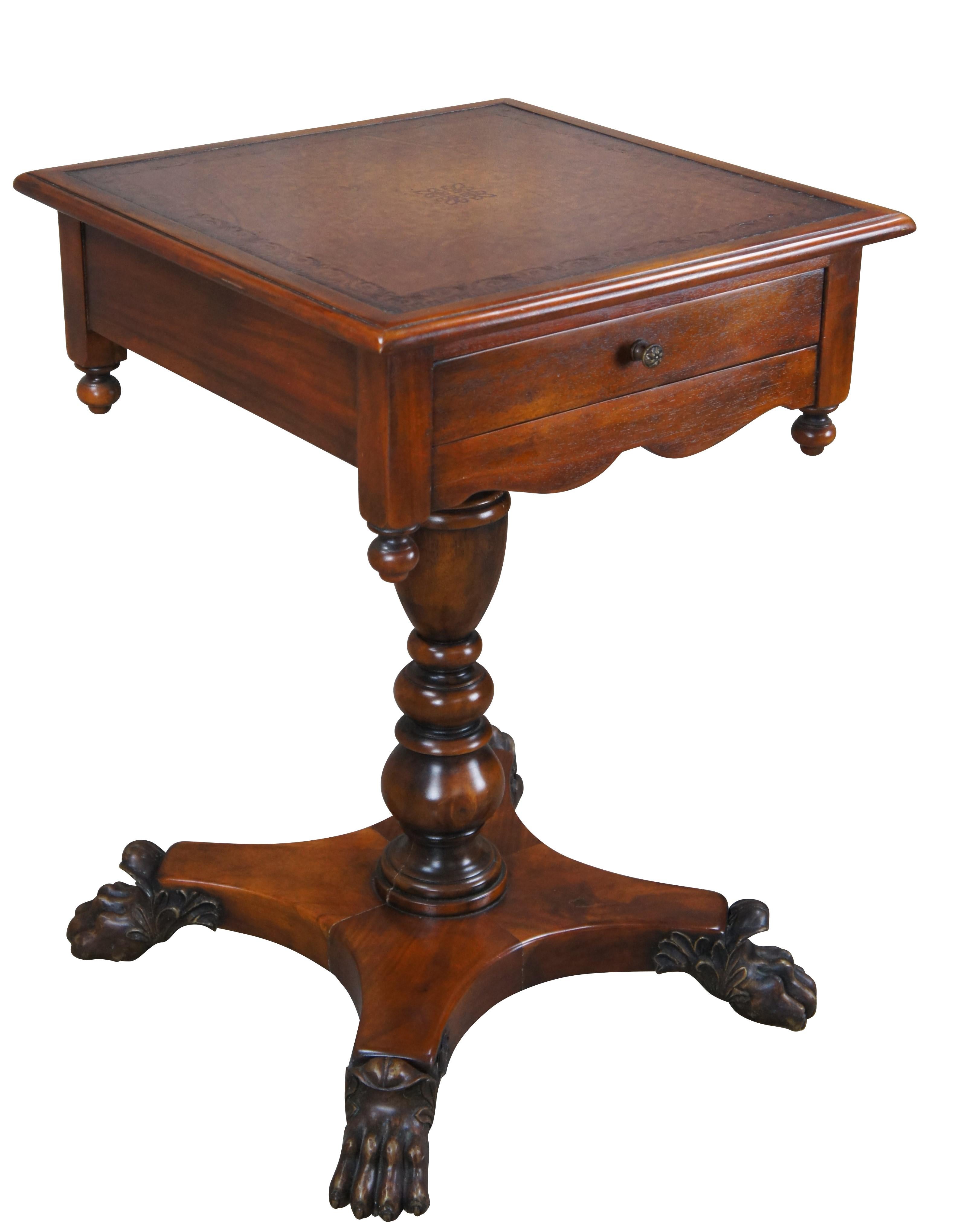 A stately American Empire style side table by Theodore Alexander, Circa late 20th century. This table is styled after a period example from the 1830s. Features a square form Made from mahogany with a topped leather top over frieze with dovetailed