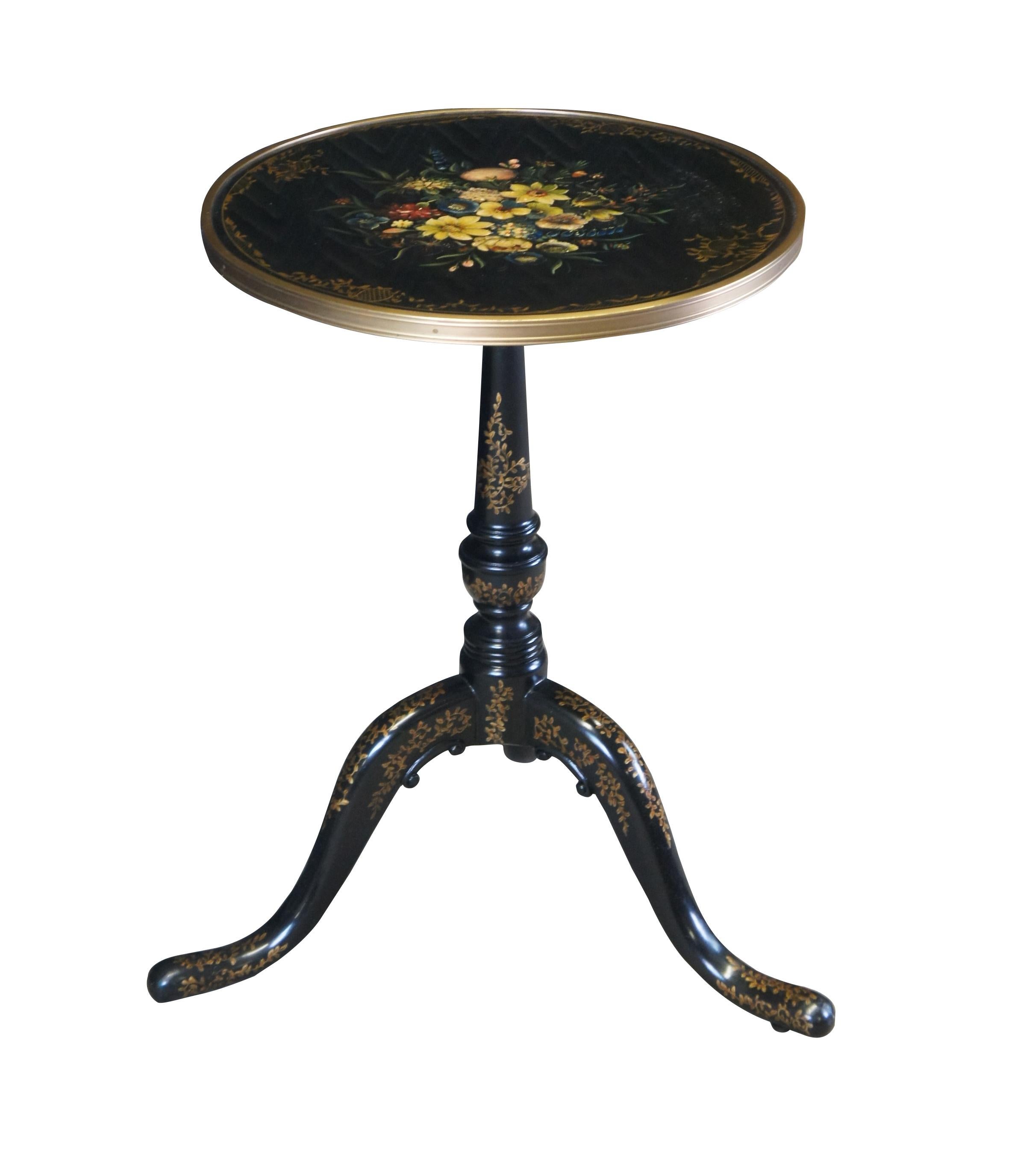 An exquisite side table by Theodore Alexander.  Features a brass banded round top with baroque style floral painted scene.  The top is supported by a graduated baluster turned support with trophy urn towards the bottom and ribbed accents.  The