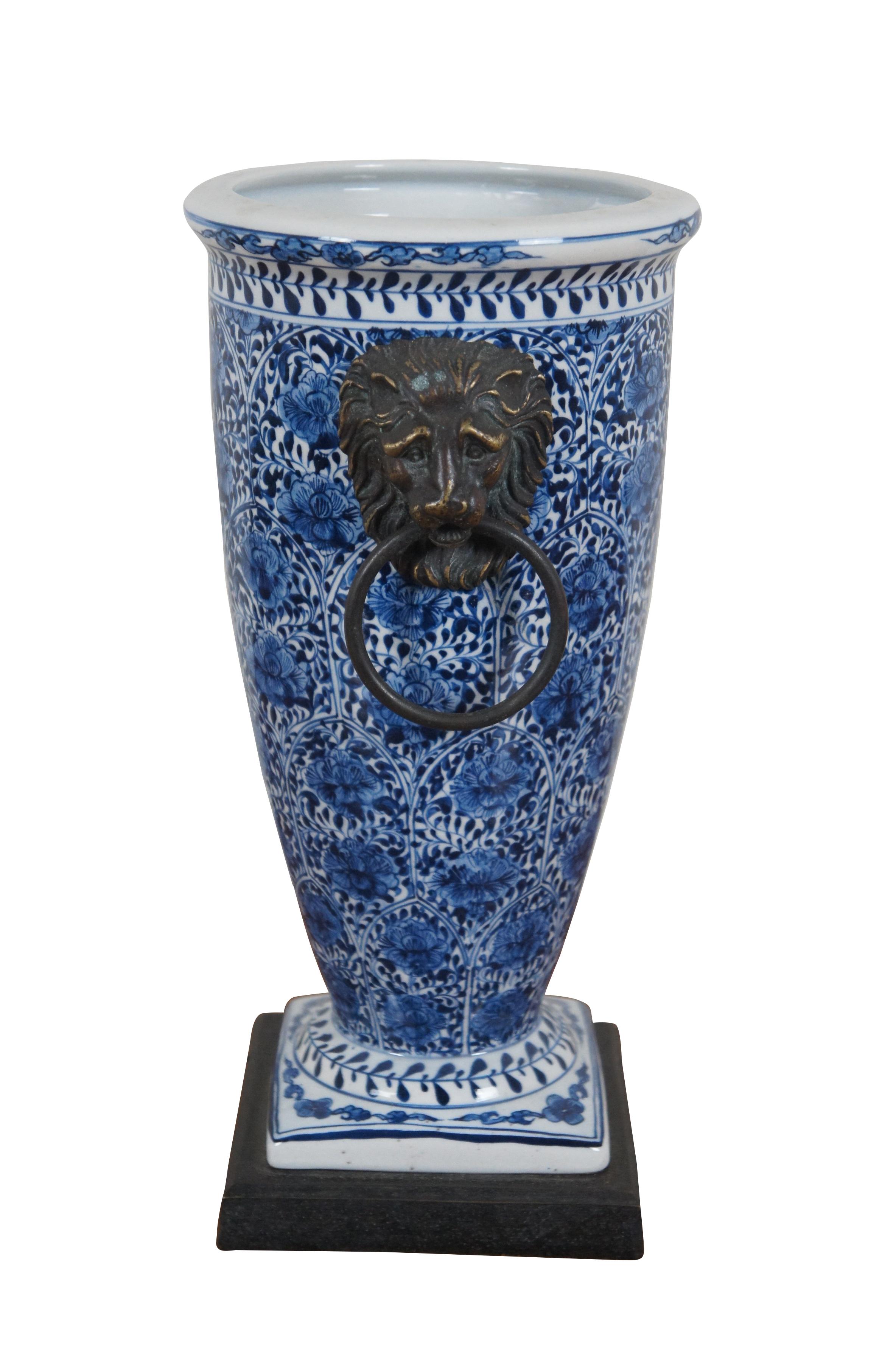 Vintage blue and white lotus flower porcelain vase with metal plinth base and  lion's head holding ring handles. Attributed to Theodore Alexander.

Dimensions:
7.5