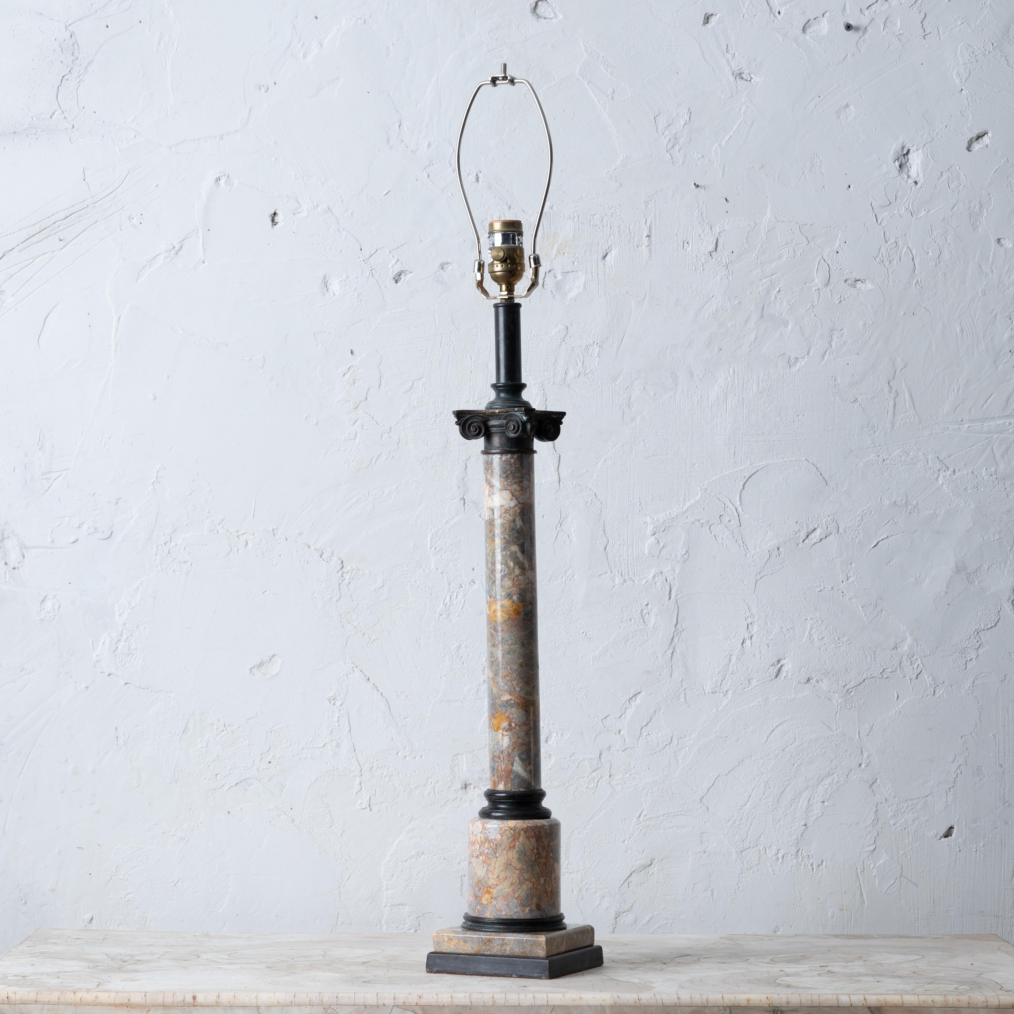 A Theodore Alexander grand tour style bronze and marble column lamp.

5 inches wide by 5 inches deep by 33 ½ inches tall; 20 ¾ inches tall to top of capital

