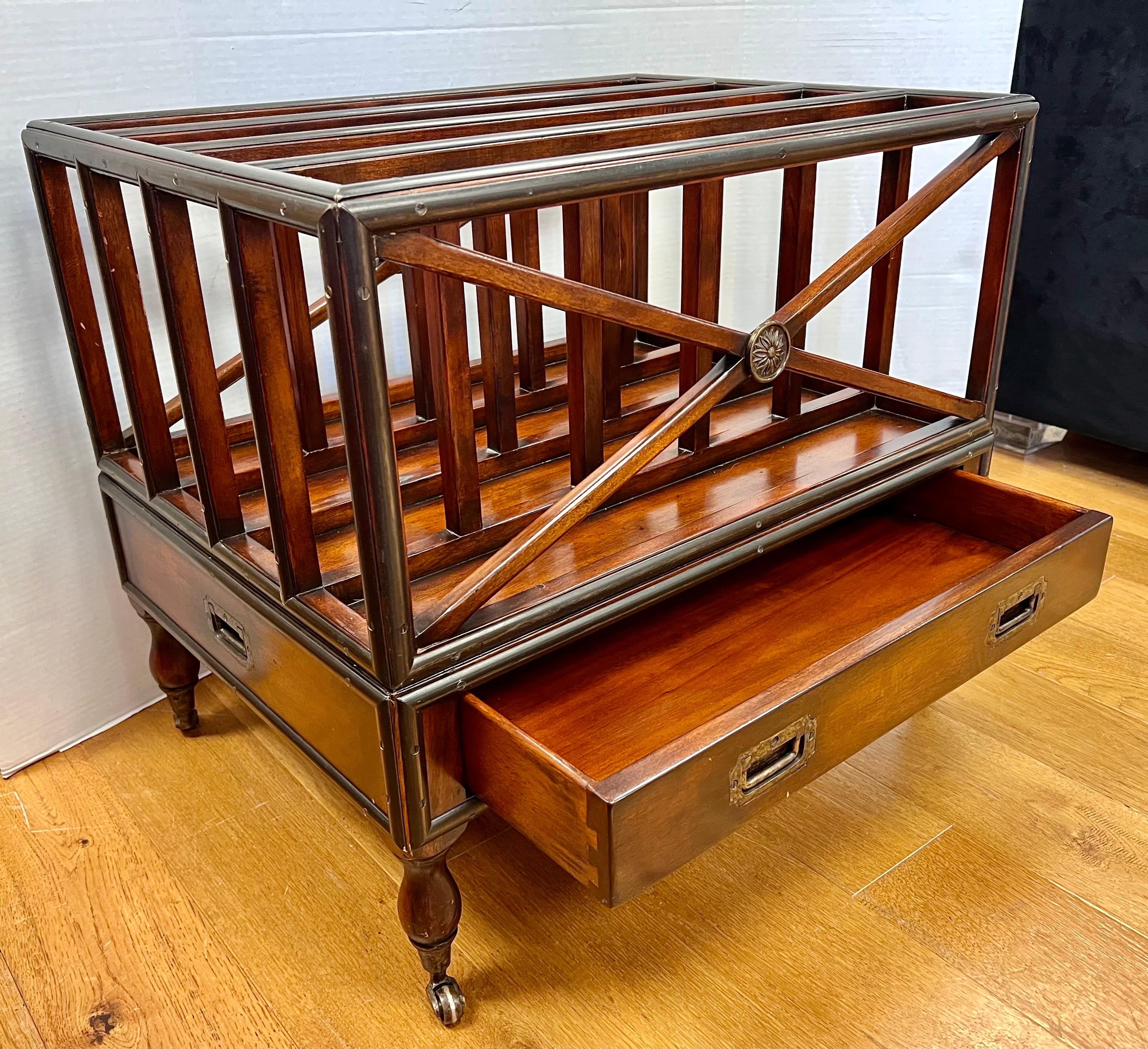 Elegant, signed Theodore Alexander magazine rack which is based on the original design from the 1800s to store sheet music. The piece is perfect for storing magazines, books or vinyl. The luxurious mahogany frame has four divisions and sports a