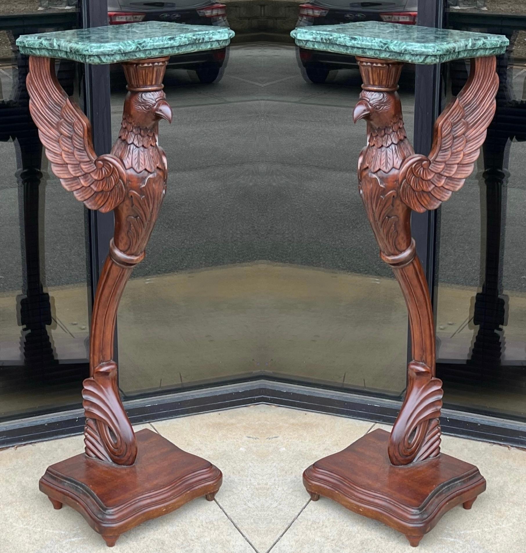 These are statement pieces! This is a pair of late 20th century pedestals or side tables by Theodore Alexander. The green marble tops are removable. The pedestals are carved mahogany. They are in very good condition.

      