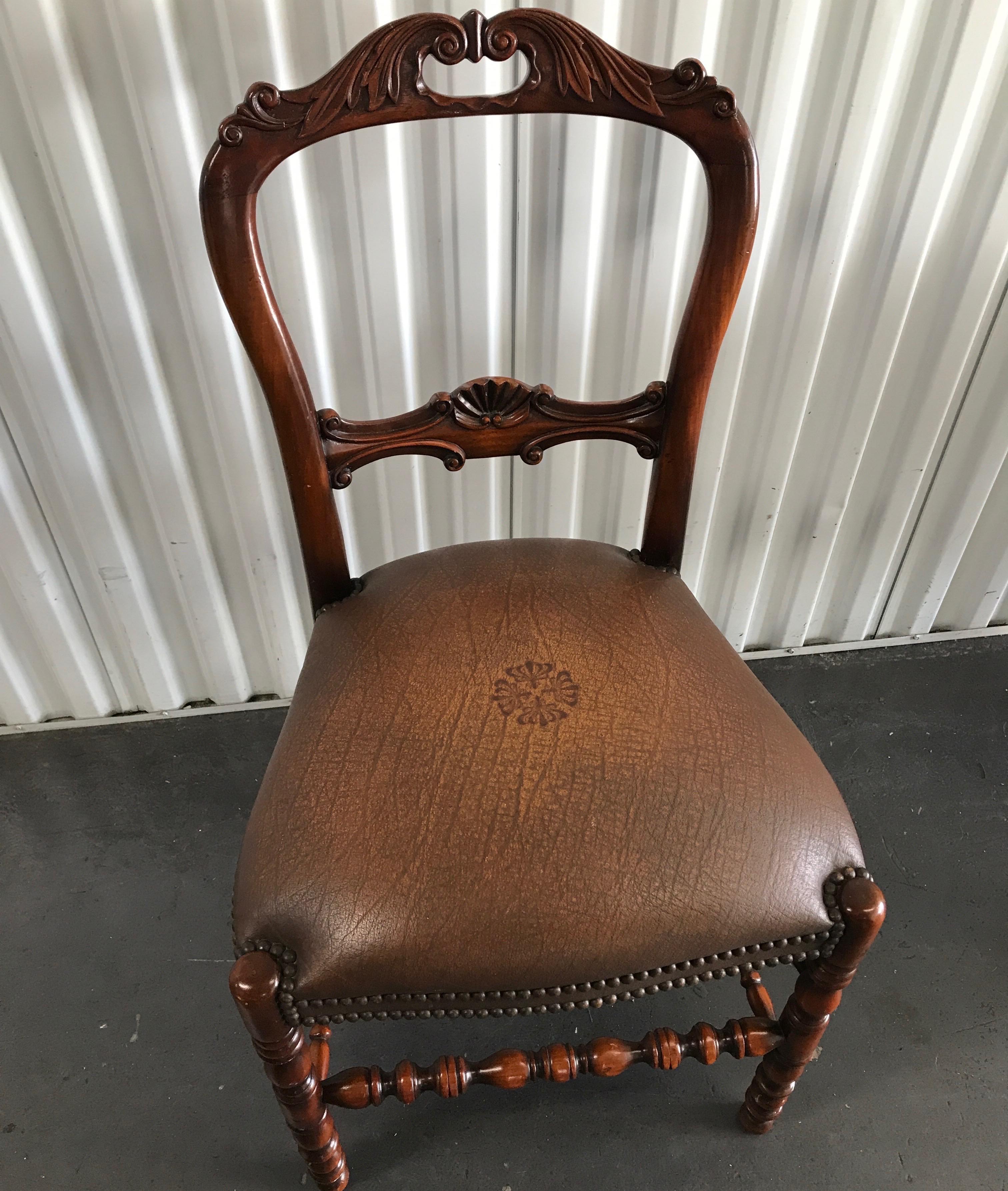 Carved wood desk chair with embossed leather studded seat by Theodore Alexander.