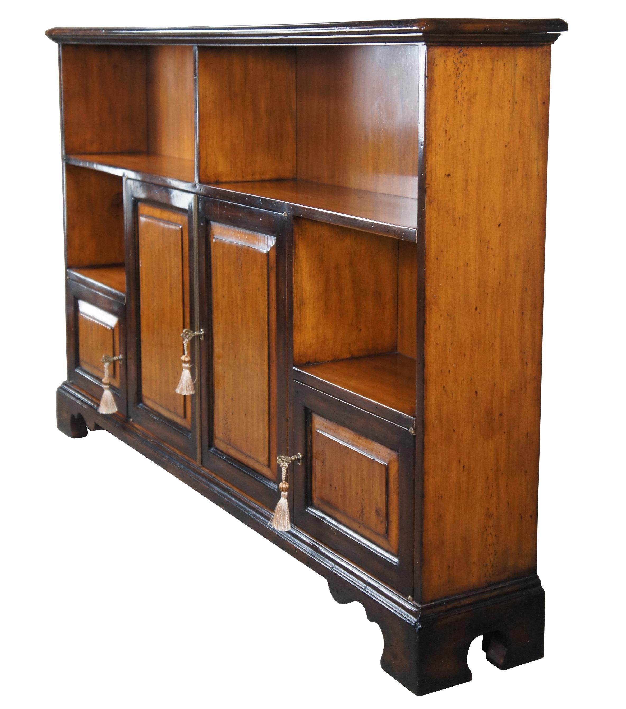 Vintage Theodore Alexander Chateau du Vallois petite console or book shelf cabinet, circa last quarter 20th century. Made of mahogany with a two tone French Provincial styling. Features a slender rectangular frame with cubbies for books or